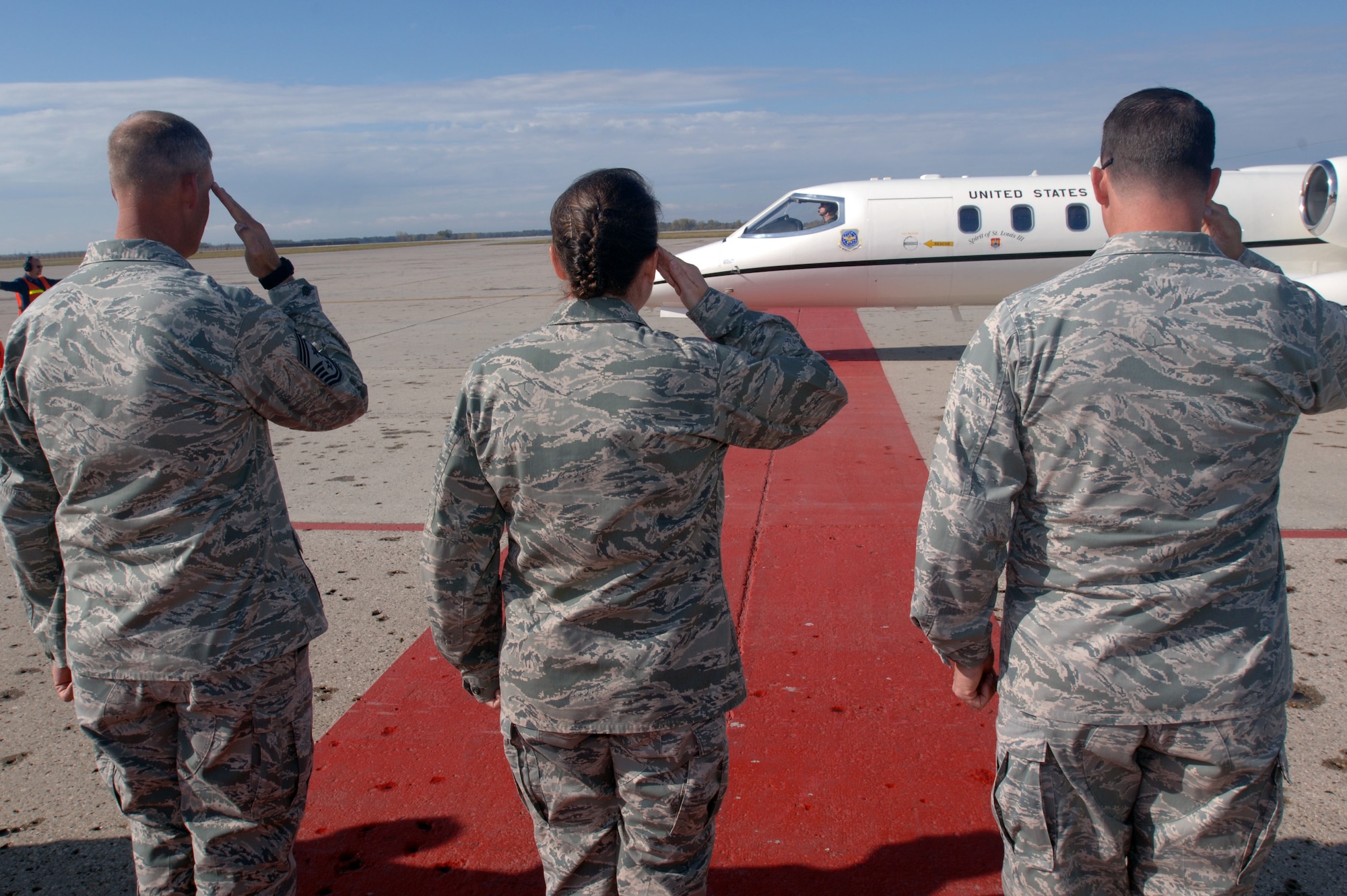 From right: Col. Tim Bush, commander of the 319th Air Base Wing, Col. Tammy Knierim, commander of the 319th Mission Support Group, and Chief Master Sgt. David Carlson, 319th ABW command chief master sergeant, salute the arrival of Terry Yonkers, Assistant Secretary of the Air Force of Installations, Environment and Logistics, as he arrives at Grand Forks Air Force Base, N.D., on Oct. 12. (U.S. Air Force photo/Tim Flack)