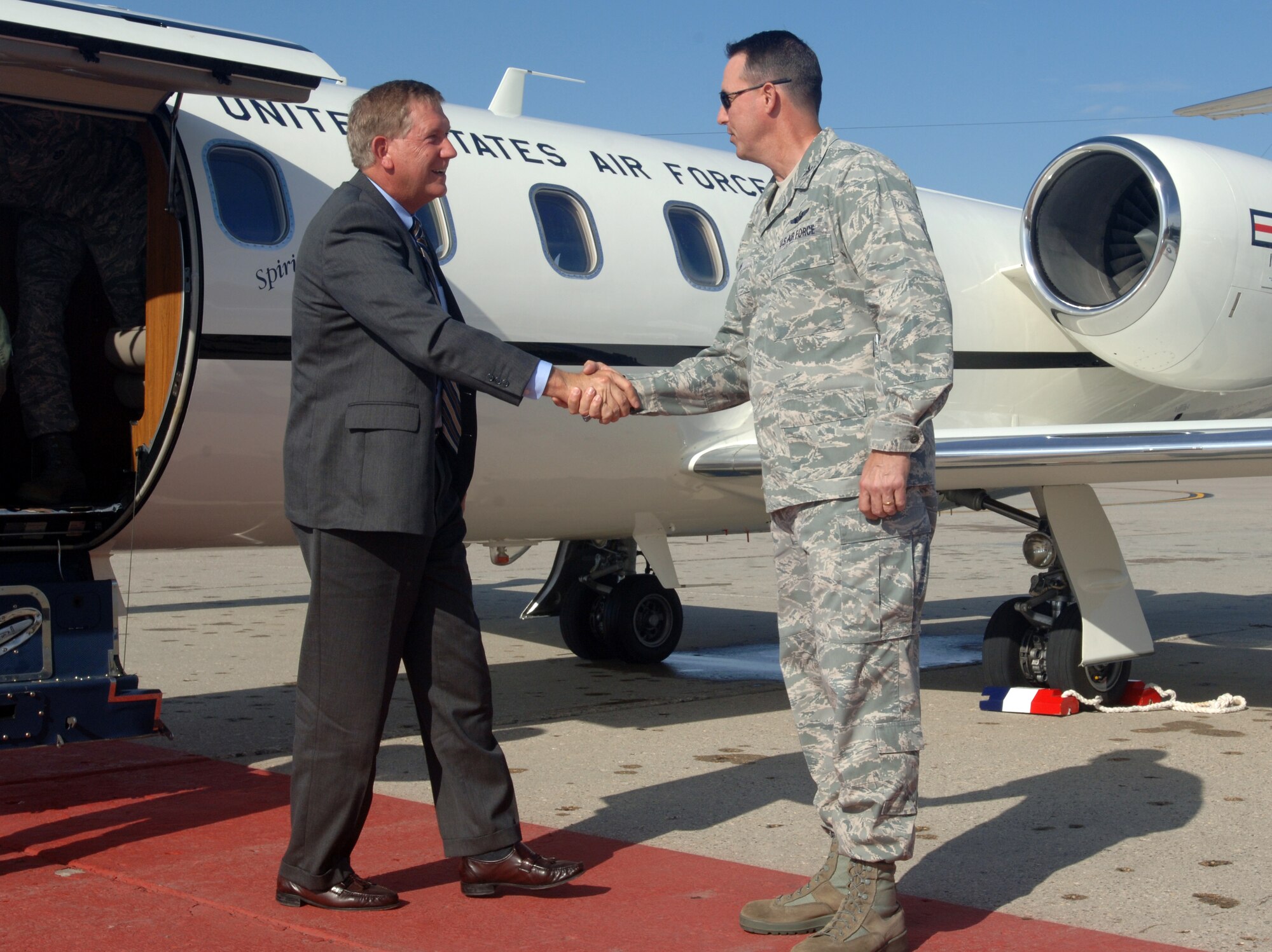 Col. Tim Bush, commander of the 319th Air Base Wing, greets Terry Yonkers, Assistant Secretary of the Air Force for Installations, Environment and Logistics, as he arrives at Grand Forks Air Force Base, N.D., on Oct. 12. (U.S. Air Force photo/Tim Flack)