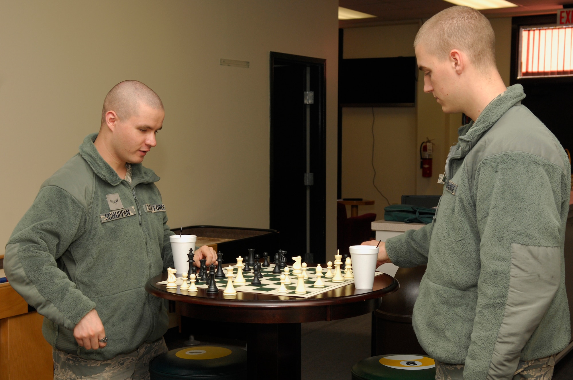 U.S. Air Force Airman 1st Class Aarron Schuppan and Airman 1st Class Corbin Trusdle, 20th Communications Squadron, play a game of chess while at the Community Center, Shaw Air Force Base, S.C. Oct. 13, 2011. The Shaw Community Center game room has 6 Xbox systems and 2 Playstation 3 systems as well as 150 games. (U.S. Air Force photo by Airman 1st Class Ashley L. Gardner/ Released)