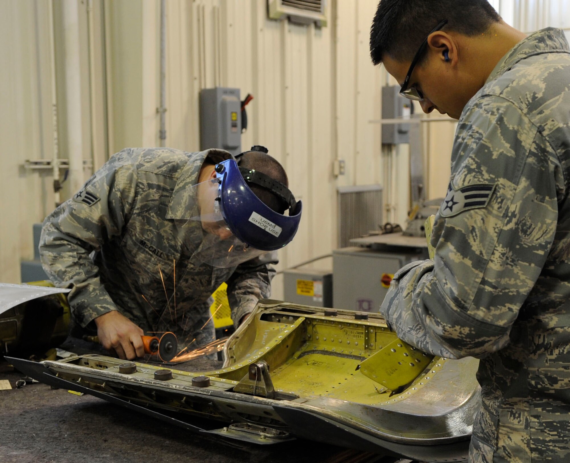 Senior Airman Colton McCall and Senior Airman Joshua Flores, 2nd Maintenance Squadron aircraft structural maintenance journeymen, work together to fix a drag chute door from a B-52 Oct. 13 at Barksdale Air Force Base, La. McCall and Flores are active-duty Airmen working with reservists at the 307th Maintenance Squadron as part of the Total Force Integration Program. (U.S. Air Force photo/Airman 1st Class Andrea F. Liechti)(RELEASED)