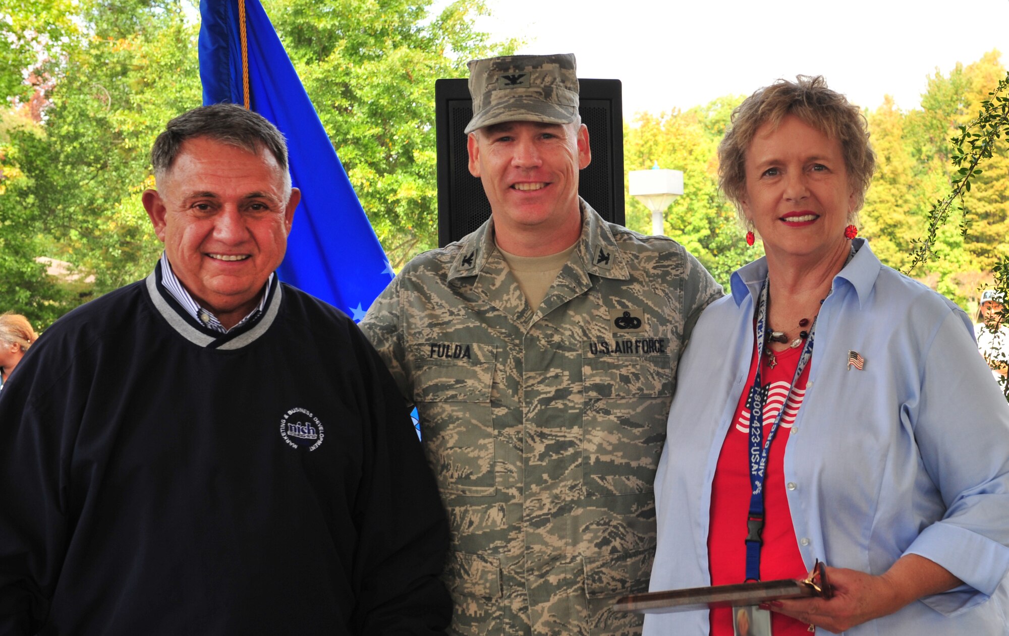 Dave Theimer, National Institution of Severely Handicapped vice president of marketing, presents U.S. Air Force Col. Walter Fulda, 20th Missions Support Group commander, and Judith Croxton, 20th Contracting Squadron director of business operation, with an AbilityOne appreciation award for Team Shaw during the AbilityOne appreciation picnic at the Memorial Lake pavilion at Shaw Air Force Base, S.C. Oct. 13, 2011. Shaw sponsors the AbilityOne picnic annually in support of National Disability Employment Awareness Month. (U.S. Air Force photo by Airman 1st Class Amber E. N. Jacobs/Released)