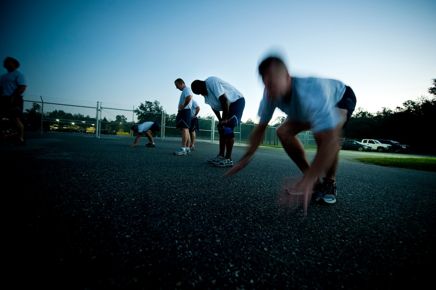 Members of the 820th Base Defense Group complete burpee repetitions during the annual LeeBernard Chavis Memorial Workout Oct. 14, 2011, at Moody Air Force Base, Ga. Participants completed 150 repetitions before beginning a one-mile run. (U.S. Air Force photo by Staff Sgt. Jamal D. Sutter/Released) 