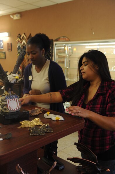 Marilyn Williams, Arts and Crafts manager, and Maria Ramos, employee, look at ornament materials Oct. 11, 2011 in the Arts and Crafts center at Dyess Air Force Base, Texas. The center is selling personalized ornaments to Dyess members and the Abilene community. (U.S. Air Force photo by Airman 1st Class Cierra Bullock/ Released)