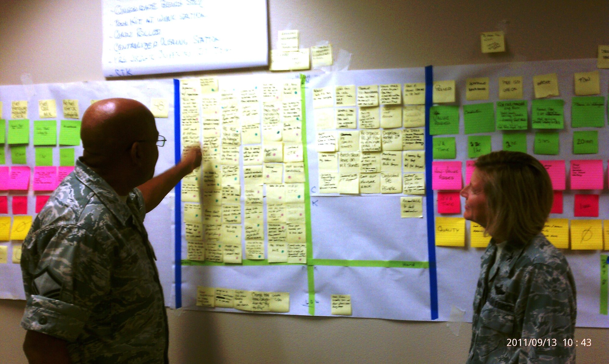 During a 452nd Maintenance Group process improvement event, Master Sgt. Derrick Jones explains the feasibility of the numerous time-saving KC-135 periodic evaluation options to Col. Mary Aldrian, 452nd Air Mobility Wing Commander, Sept. 13, 2011.  (U.S. Air Force photo/Capt. Jess Lozano)