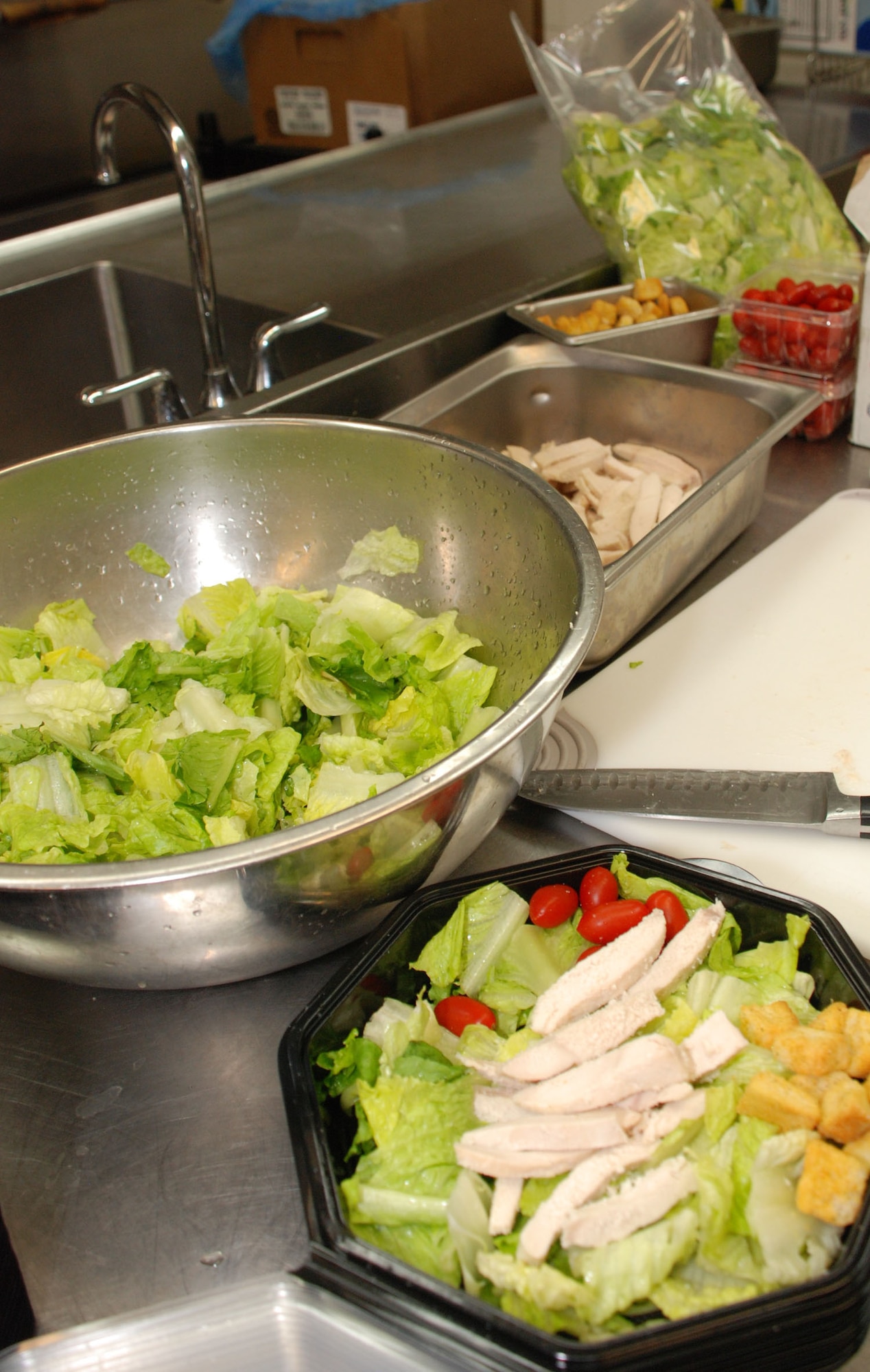 In the kitchen of the Hap Arnold Club at March Air Reserve Base, Calif., cooks prepare a healthy chicken salad, Sept. 11, 2011. A year-long nutrition project encouraged the club to provide healthier food options to support a culture of fitness on base.  (U.S. Air Force photo/Senior Airman Patrick Cabellon)