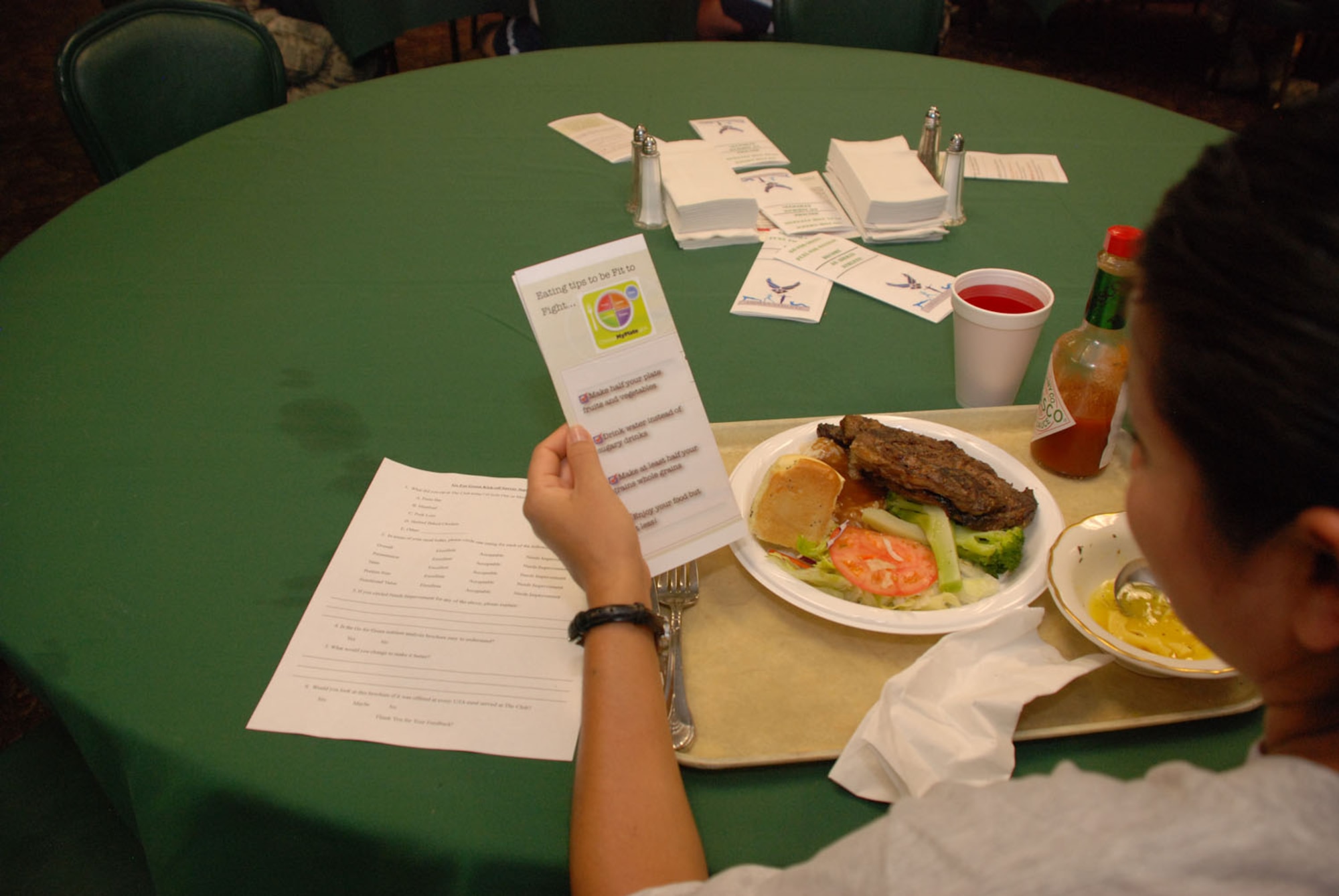 An Airman reviews a healthy eating pamphlet during lunch at the Hap Arnold Club at March Air Reserve Base, Calif., Sept. 11, 2011.  The pamphlets are a result of a year-long nutrition project designed to support Airmen's Fit-to-Fight and deployment fitness requirements. (U.S. Air Force photo/Senior Airman Patrick Cabellon)