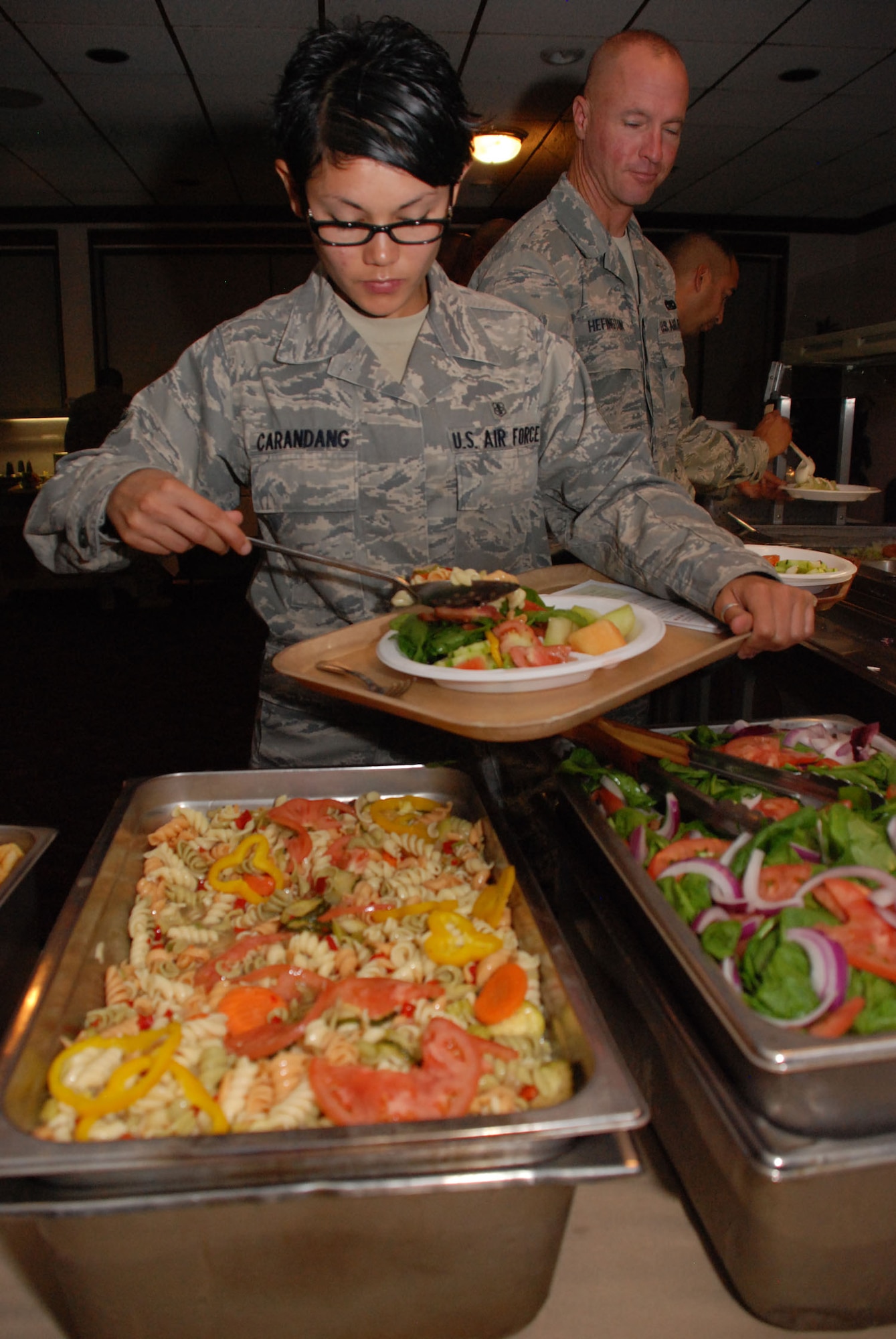 Senior Airman Lynnette Carandang, a medical technician with the 452nd Aeromedical Staging Squadron, scoops pasta salad onto her plate during lunch at the Hap Arnold Club at March Air Reserve Base, Calif., Sept. 11, 2011.  Carandang is a vegetarian and a squadron fitness leader and said she appreciates the new, healthy troop feeding menu at the club. (U.S. Air Force photo/Senior Airman Patrick Cabellon)