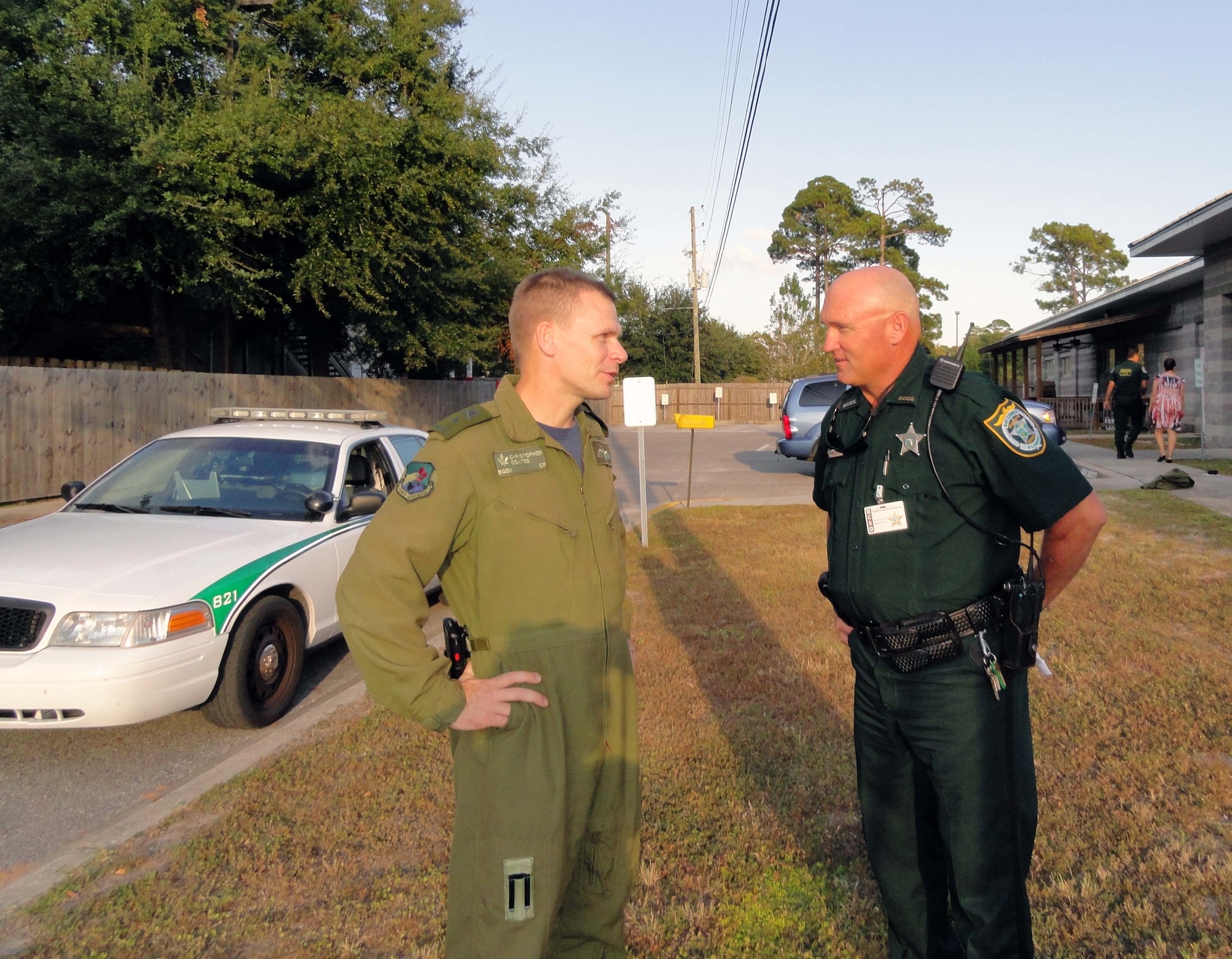 BGen. Christopher Coates, Continental U.S. North American Aerospace Defense Region deputy commander talks with Bay County Sheriff’s Office Deputy Scott Frazier. Coates rode along with Frazier the majority of the evening patrolling the Panama City Beach area. (Air Force Photo by Mary McHale)