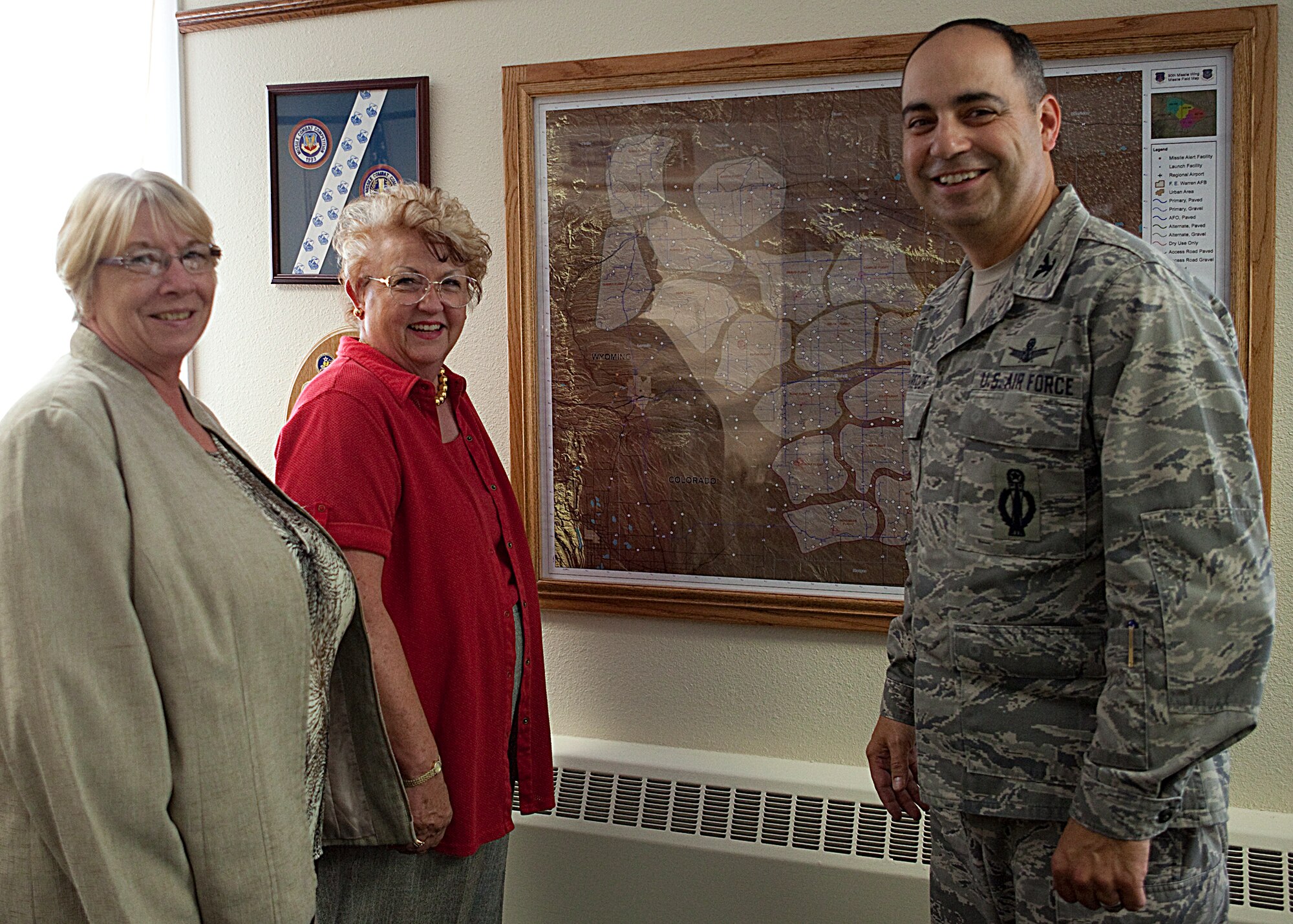 Col. George Farfour, 90th Missile Wing vice commander, discusses the unique challenges of the 90th MW mission that takes place over an area the size of Vermont with Joan Sell, immediate former National Air Force Association secretary, and Jeri Andrews, Colorado State vice president of programs and development, while in his office Oct. 6. (U.S. Air Force photo by Matt Bilden)