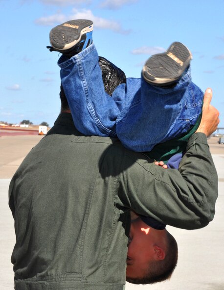 TRAVIS AIR FORCE BASE, Calif. --Col. Al Lupenski uses five-year-old Jack Flournoy as a towel after the child gave "Uncle Al" a cold hosing down after his "fini" flight. Col. Lupenski, 349th Operations Group commander, is off to Scott AFB, Ill., to assume duties as the wing commander for the 932nd AW. Jack is the son of 349th Wing Commander, Col. Jay Flournoy. (U.S. Air Force photo/Senior Master Sgt. Ellen L. Hatfield)