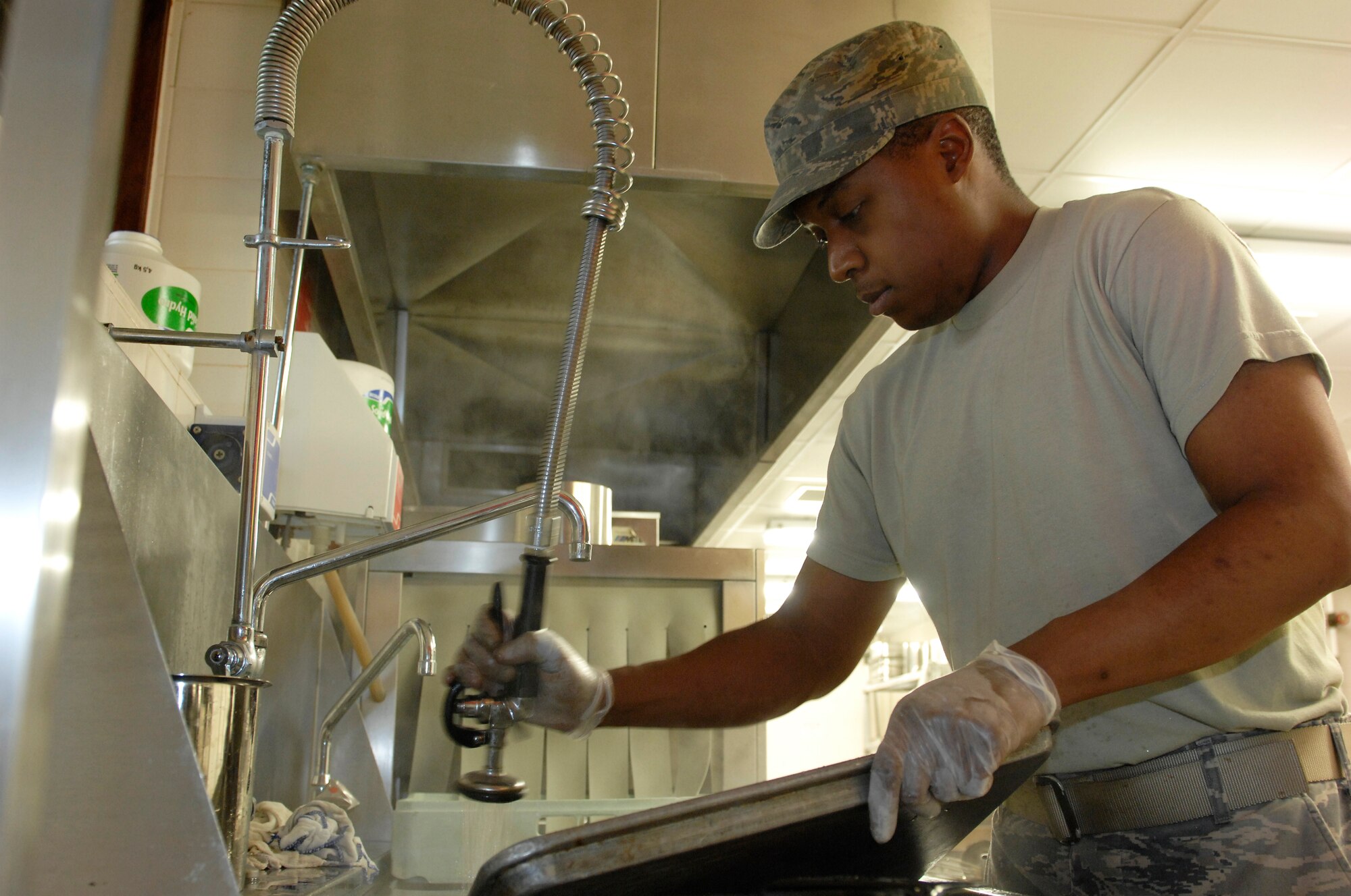 ROYAL AIR FORCE LAKENHEATH, England--Senior Airman Adam Rowell, 48th Force Support Squadron chef apprentice, cleans utensils and cooking equipment in preparation of the reopening of The Knight's Table Dining Facility scheduled for Oct. 14.  The primary goal of the renovation was to bring the facility in line with current safety requirement to include a new fire suppression system, alarms, new lighting and non-slip flooring in the kitchen.  (U.S. Air Force photo by Tech. Sgt. Lee A. Osberry Jr.)
