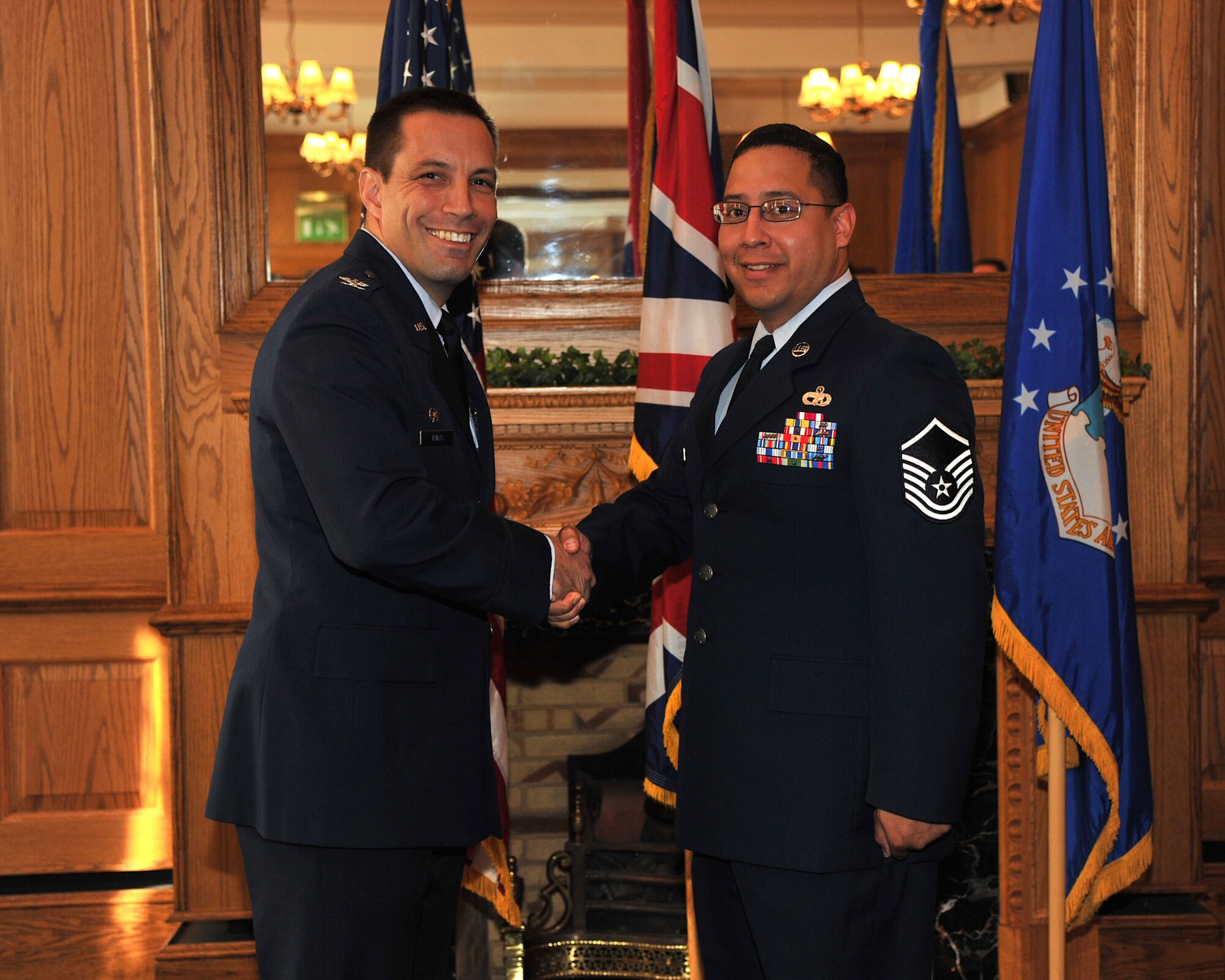 U.S. Air Force Master Sgt. Adrian Rivera, from the 100th Logistics Readiness Squadron, shakes hands with Col. Christopher Kulas, the commander of the 100th Air Refueling Wing, after receiving a British-American Council’s community relations award Sept. 24, 2011, at RAF Mildenhall, England. (U.S. Air Force photo by SrA Jerilyn Quintanilla) 
