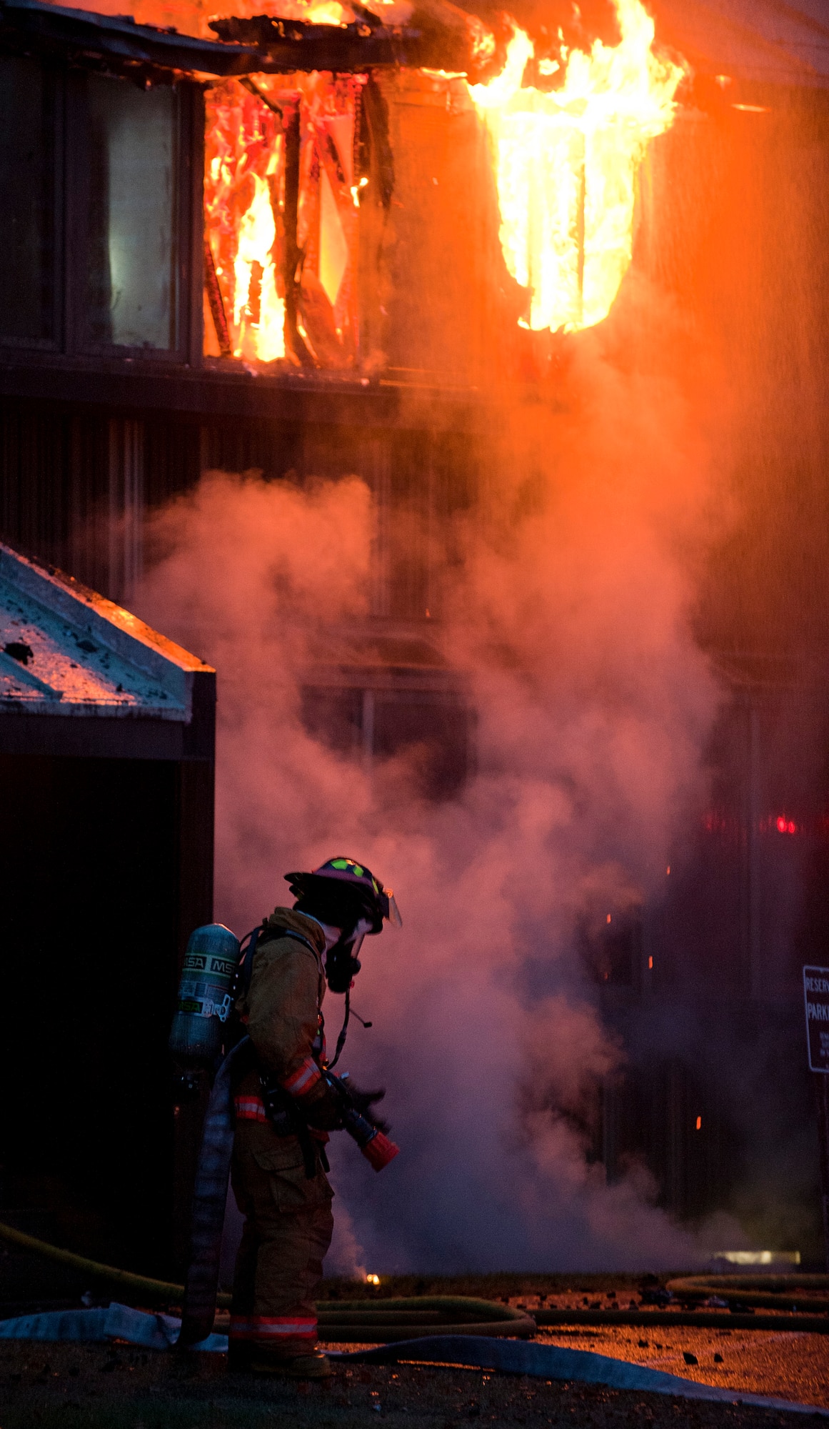 A Joint Base Elmendorf-Richardson firefighter prepares to battle a fire at building 9386 on JBER October 13, 2011. All occupants of the lodging facility were accounted for and no injuries were reported. (U.S. Air Force photo/Staff Sgt. Zachary Wolf)(Released)