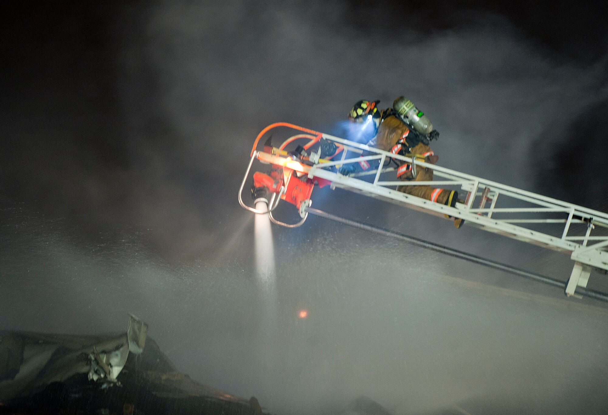 A Joint Base Elmendorf-Richardson firefighter battles a fire at building 9386 on JBER October 13, 2011. All occupants of the lodging facility were accounted for and no injuries were reported. (U.S. Air Force photo/Staff Sgt. Zachary Wolf)(Released)