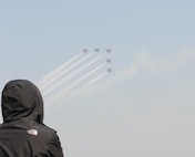 A Korean national watches as a flight of ‘Black Eages’, the Republic of Korea Air Force’s aerial demonstration team, flies across the sky during the 2011 Gunsan--Saemangeum Air Show at Gunsan City, Republic of Korea, Oct. 9, 2011. The air show featured many static displays and performances from across the Pacific Air Forces and Korean peninsula. (U.S. Air Force photo by Staff Sgt. Robert Webb/Released)
