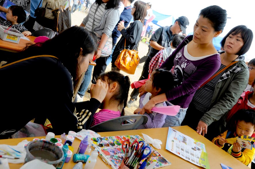 A young Korean girl gets her face painted at the 2011 Gunsan-Saemangeum Airshow in Gunsan City, Republic of Korea, Oct. 9, 2011. The City of Gunsan, the 8th Fighter Wing and the Republic of Korea Air Force’s 38th Fighter Group hosted the air show. There were about 170,000 civilians and military attendees over the two-day period that came out for the air show. (U.S. Army photo by Spc. Christopher Wellner/Released)