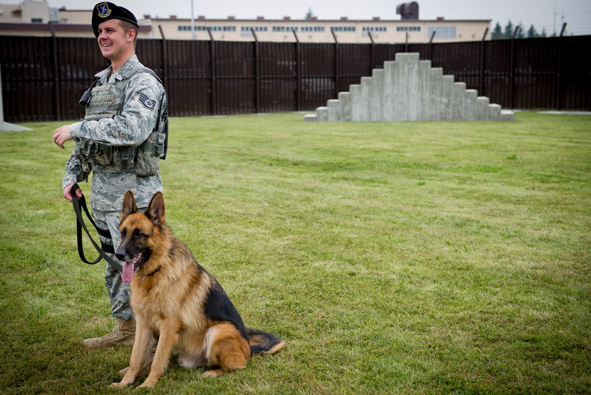 YOKOTA AIR BASE, Japan  -- Staff Sgt. William Hollendonner, military working dog handler,  374th Security Forces Squadron prepares to run his dog  through the obstacle course Oct. 11, 2011 at Yokota Air Base, Japan. The MWD handlers run their dog through the course everyday to give them exercise and keep them trained to do their job. The MWD handlers work side-by-side with their dogs to provide base security as well as searching vehicles for illegal drugs, and explosives. (U.S. Air Force Photo/ Staff Sgt. Stacy Moless)
