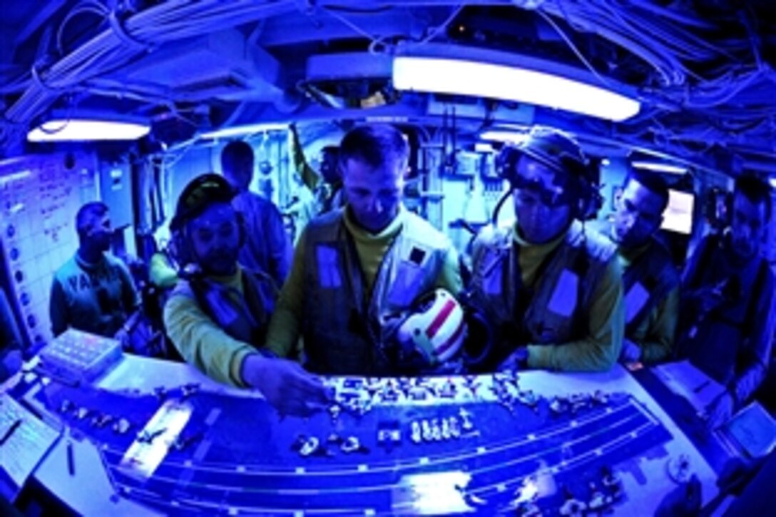 U.S. Navy seamen prepare for night flight operations in flight deck control aboard the USS John C. Stennis in the Arabian Sea, Oct. 11, 2011. John C. Stennis is deployed to the U.S. 5th Fleet area of responsibility conducting maritime security operations and support missions as part of operations Enduring Freedom and New Dawn. 