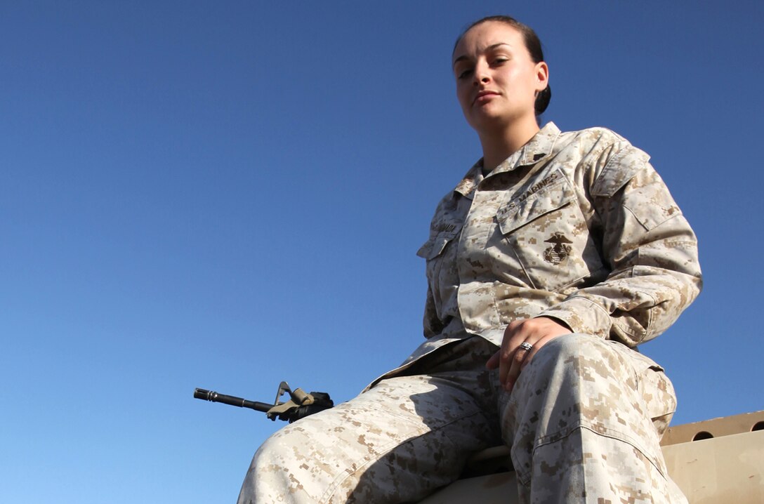 Cpl. Jaymie Ahumada sits atop a vehicle during a pause in operations aboard Camp Dwyer, Afghanistan, Oct. 15.  Ahumada, currently serving as a Headquarters and Service Company clerk with Combat Logistics Battalion 1, 2nd Marine Logistics Group (Forward), is a motor transport operator by trade.  (U.S. Marine Corps photo by Cpl. Katherine M. Solano)