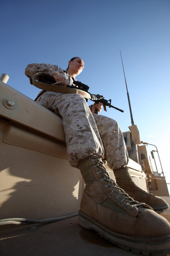 Cpl. Jaymie Ahumada sits atop a vehicle during a pause in operations aboard Camp Dwyer, Afghanistan, Oct. 15.  Ahumada, currently serving as a Headquarters and Service Company clerk with Combat Logistics Battalion 1, 2nd Marine Logistics Group (Forward), is a motor transport operator by trade.  (U.S. Marine Corps photo by Cpl. Katherine M. Solano)