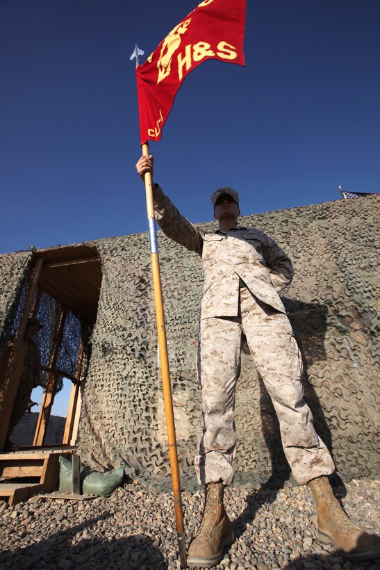 Cpl. Jaymie Ahumada presents the colors for Headquarters and Service Company, Combat Logistics Battalion 1, 2nd Marine Logistics Group (Forward), aboard Camp Dwyer, Afghanistan, Oct. 15.  As a company office clerk, Ahumada's duties range from being the training noncommissioned officer to armory clerk.  (U.S. Marine Corps photo by Cpl. Katherine M. Solano)