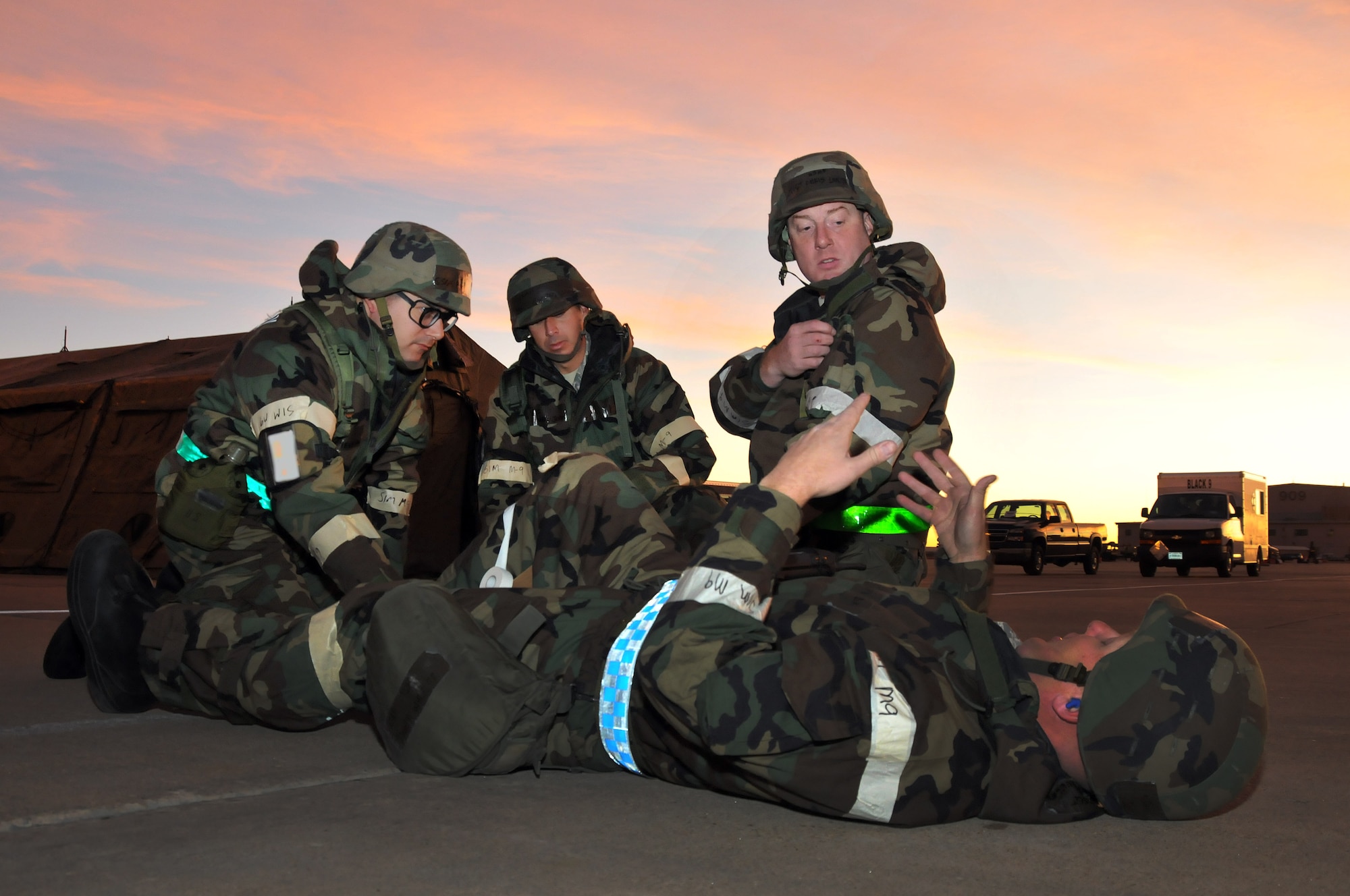 U.S. Air Force Airman from the 140th Aircraft Maintenance Squadron, react to an exercise scenario of one of their fellow members injured on the flight line during an Operational Readiness Exercise at Buckley Air Force Base Colo., October 15, 2011. Buckley Air National Guard airmen are taking part in the Operational Readiness Exercise being held on base throughout the weekend. The ORE evaluates airmen with mission readiness in preparation for real world deployments as well as next year’s Operational Readiness Inspection.  U.S. Air Force photo by: Wolfram M. Stumpf (RELEASED)