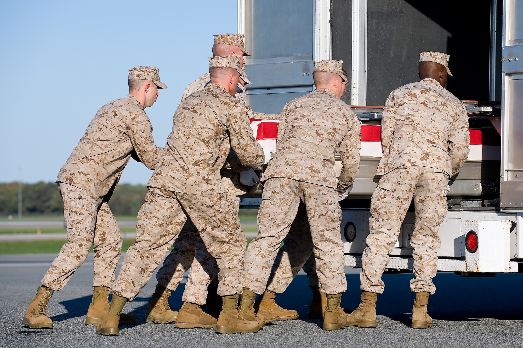 A U.S. Marine Corps carry team transfers the remains of Marine Lance Cpl. Scott D. Harper of Winston, Ga., at Dover Air Force Base, Del., Oct. 15, 2011. Harper was assigned to the 1st Battalion, 6th Marine Regiment, 2nd Marine Division, II Marine Expeditionary Force, Camp Lejeune, N.C. (U.S. Air Force photo/Adrian Rowan)