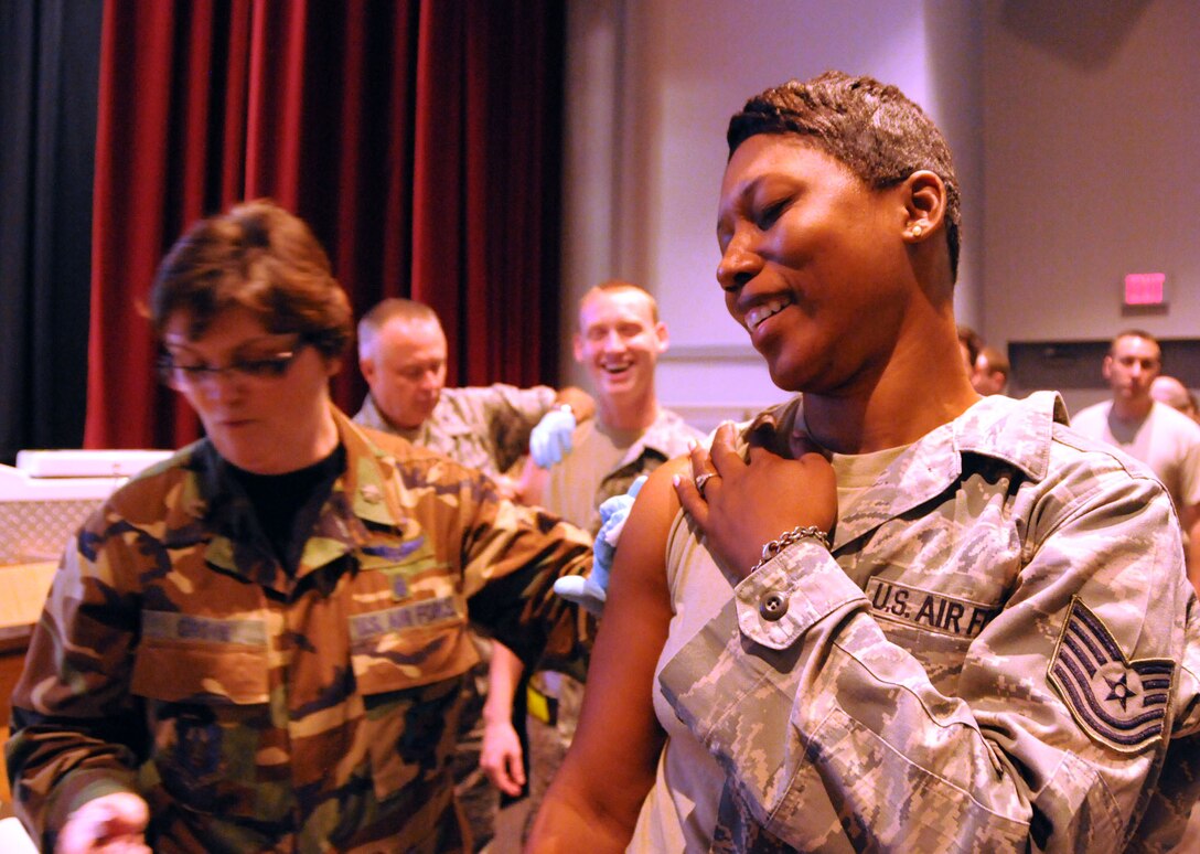 Maj. Cara Grove, 512th Aerospace Medicine Squadron nurse practitioner, administers a flu vaccination to Tech. Sgt. Kaleishia Hoskins, 46th Aerial Port Squadron fuel systems technician, in the Dover Air Force Base, Del., theater Oct. 15, 2011. The Liberty Wing provided more than 700 immunizations that day in preparation for the upcoming flu season, which most commonly peaks in the United States in January or February. (U.S. Air Force photo/Staff Sgt. Andria J. Allmond)