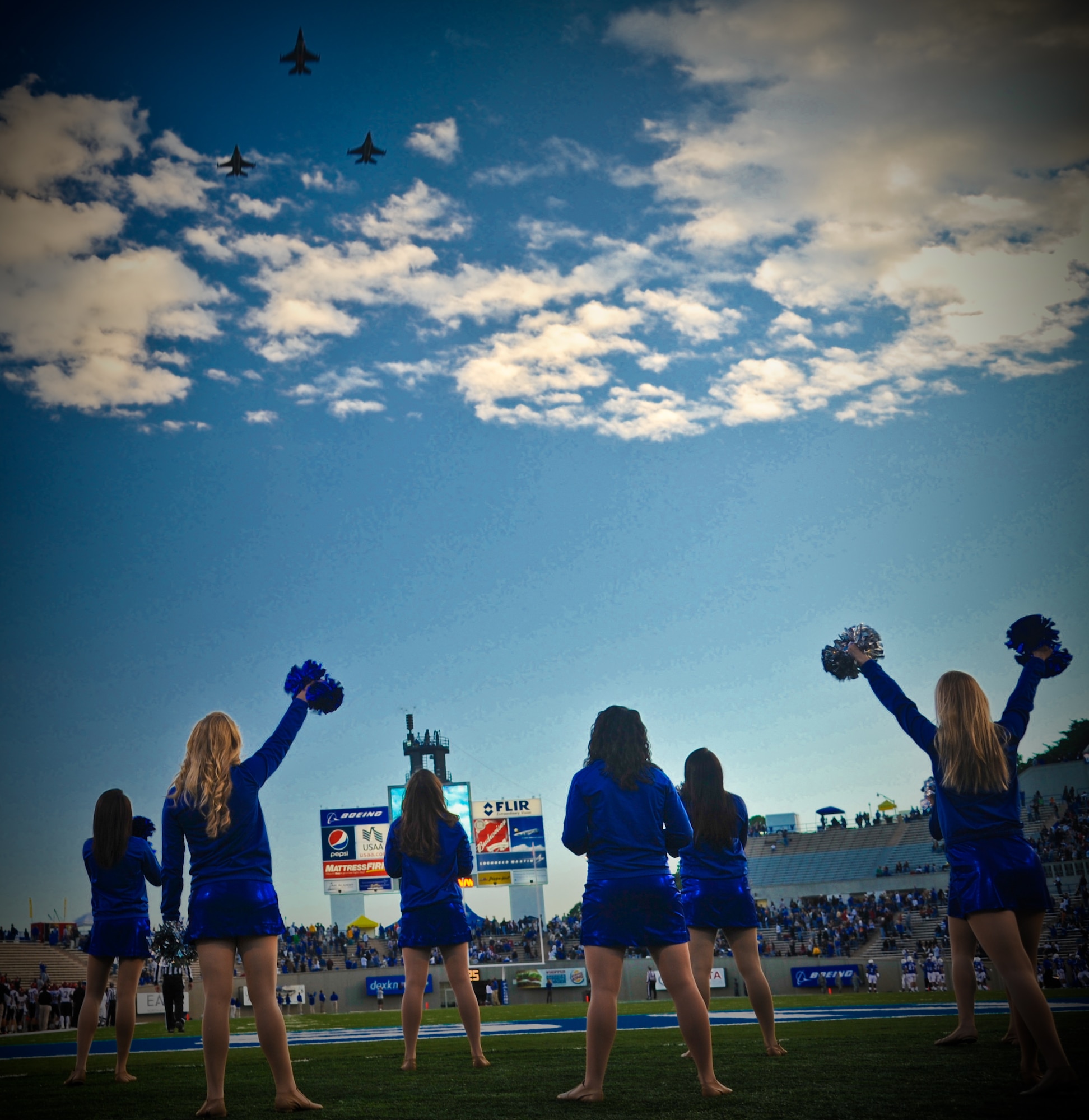 Three F-16 Fighting Falcons roar overhead at the U.S. Air Force Academy's Falcon Stadium in Colorado Springs, Co., Oct. 13. The flyover was part of a pregame show for a USAFA Falcons vs. San Diego State University football game. (U.S. Air Force Photo/Senior Airman Lauren Main)
