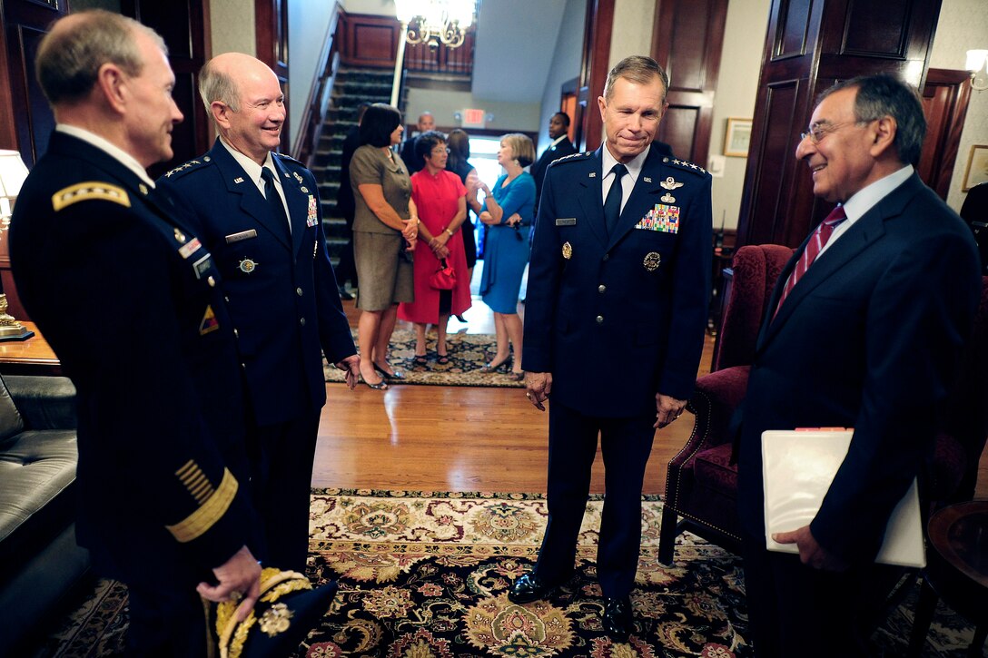 Defense Secretary Leon E. Panetta, right, and Army Gen. Martin E. Dempsey, chairman of the Joint Chiefs of Staff, far left, meet with Air Force Gen. William M. Fraser III, second from right, and Air Force Gen. Duncan J. McNabb, second from left, before the change-of-command ceremony for U.S. Transportation Command at Scott Air Force Base, Ill., Oct. 14, 2011. During the ceremony, Fraser succeeded Air Force Gen. Duncan J. McNabb as Transcom commander. 