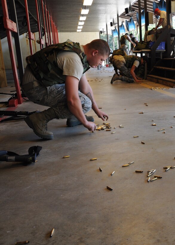 SrA Kenneth A. Childress, a pavement and construction equipment operator assigned to the 560th Red Horse Squadron at Joint Base Charleston, S.C., collects the empty ammunition casings after participating in combat arms training and maintenance qualification October 15, 2011. (U.S. Air Force photo by Senior Airman Robert Pilch)