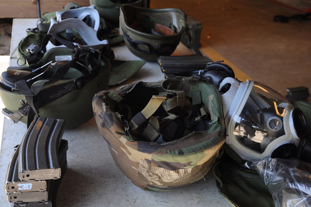 Gas masks, protective headgear and ammunition cartridges are a few of the necessary items utilized during combat arms training and maintenance at Joint Base Charleston, S.C. October 15, 2011. (U.S. Air Force photo by Senior Airman Robert Pilch)