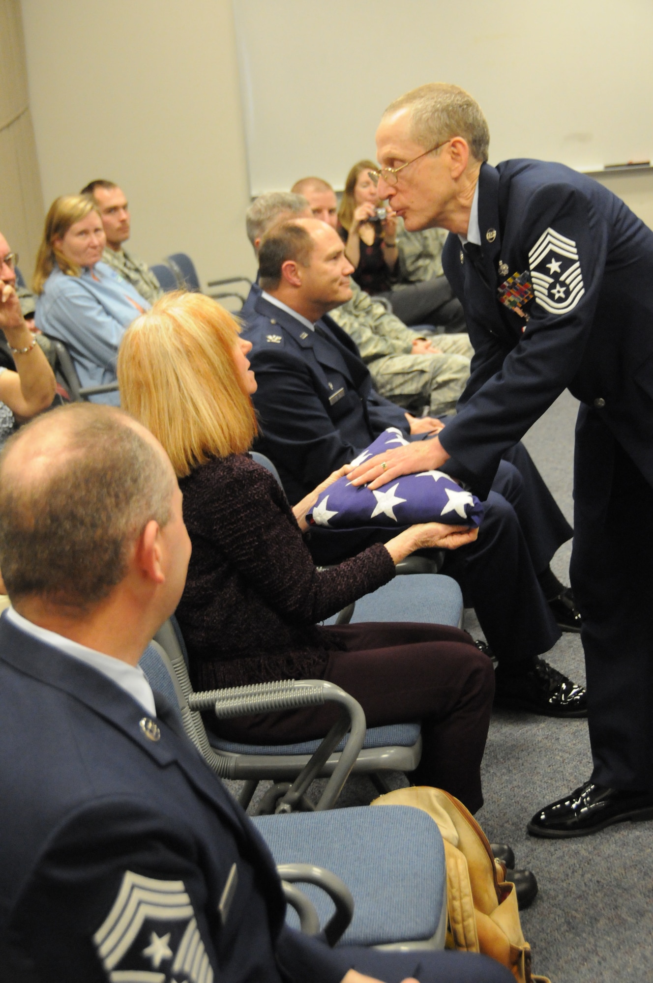 PORTLAND, Ore. - Command Chief Max White presented the U.S. flag that was folded to his wife Diane White during a ceremony to celebrate CCMSgt Max White's retirement on October 16. (Air Force photo taken by Tech. Sgt John Hughel)