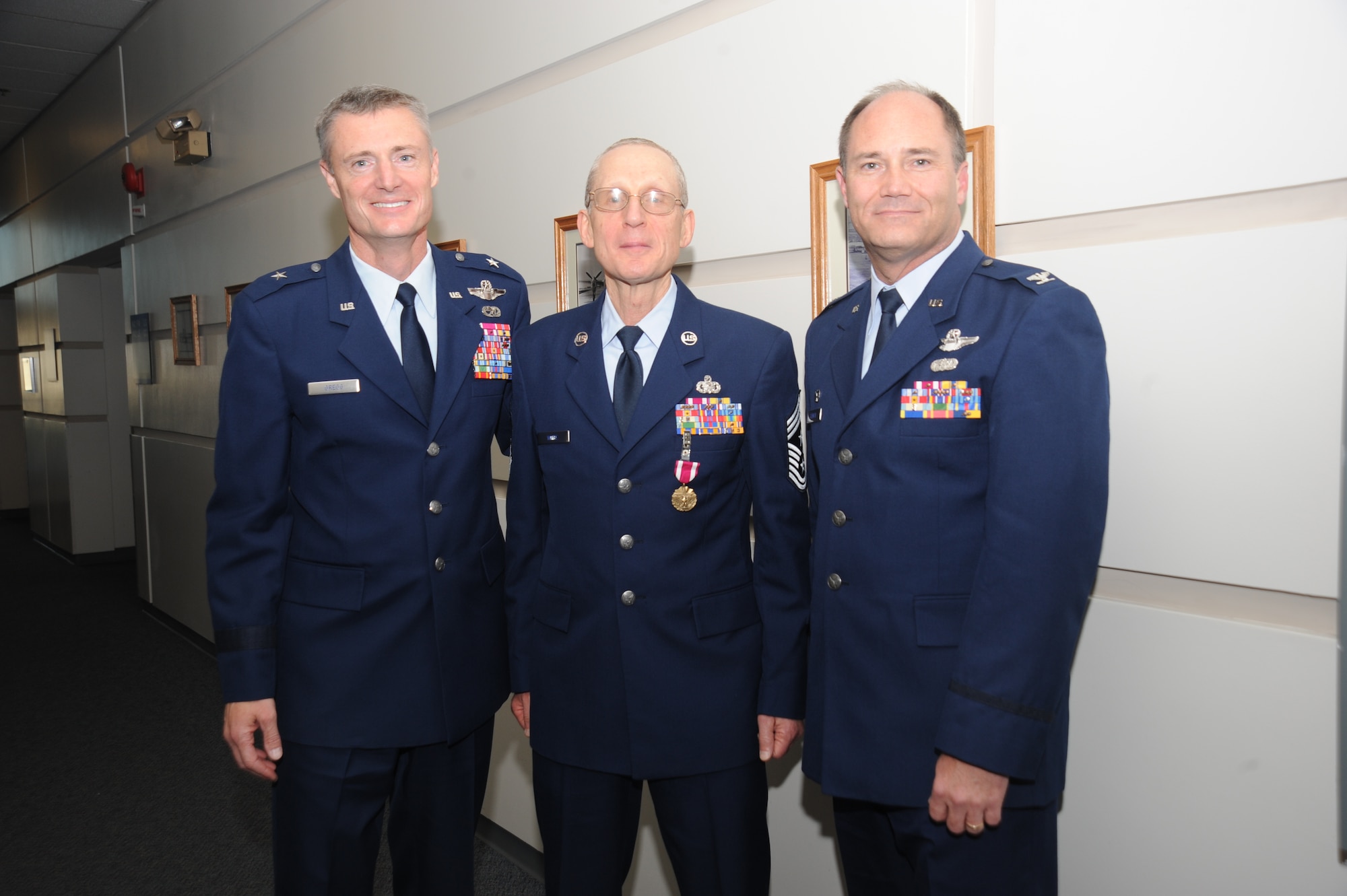 PORTLAND, Ore. - Ore. Air National Guard Commander, Brig. Gen. Steven Gregg; retired 142d Fighter Wing Command Chief, CCMSgt Max White; and 142d Fighter Wing Commander, Col. Stencel pose for a photo after Command Chief Max White was honored in a ceremony to celebrate his retirement on October 16.( Air Force photo by Tech. Sgt John Hughel)