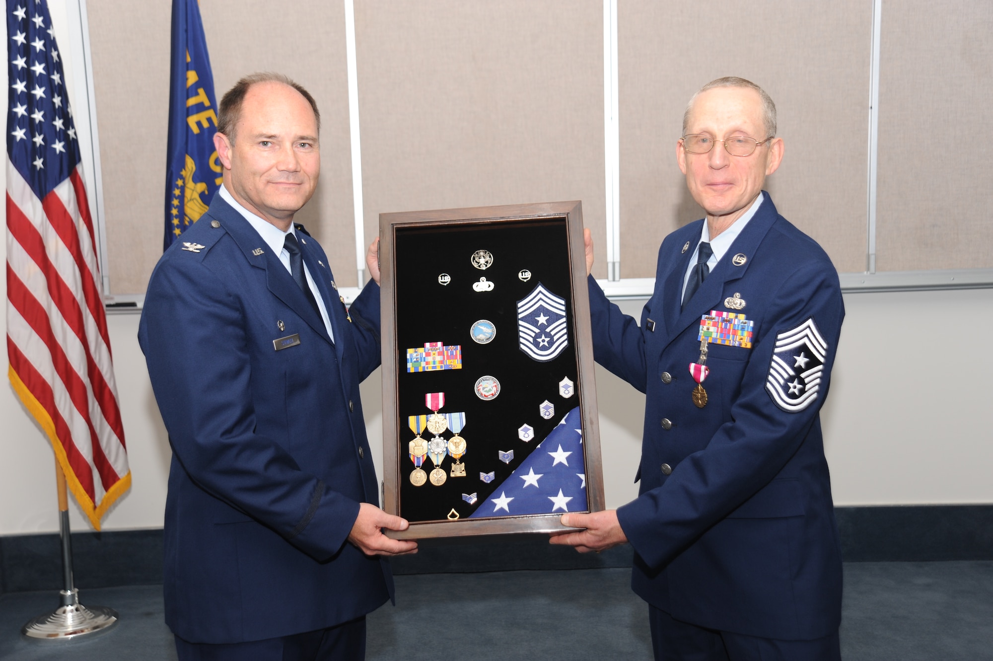 PORTLAND, Ore. - Command Chief Max White was honored in a ceremony to celebrate his retirement on October 16.142d Wing Commander, Col. Michael Stencel presents Command Chief with a shadow box representing his career.( Air Force photo by Tech. Sgt John Hughel)