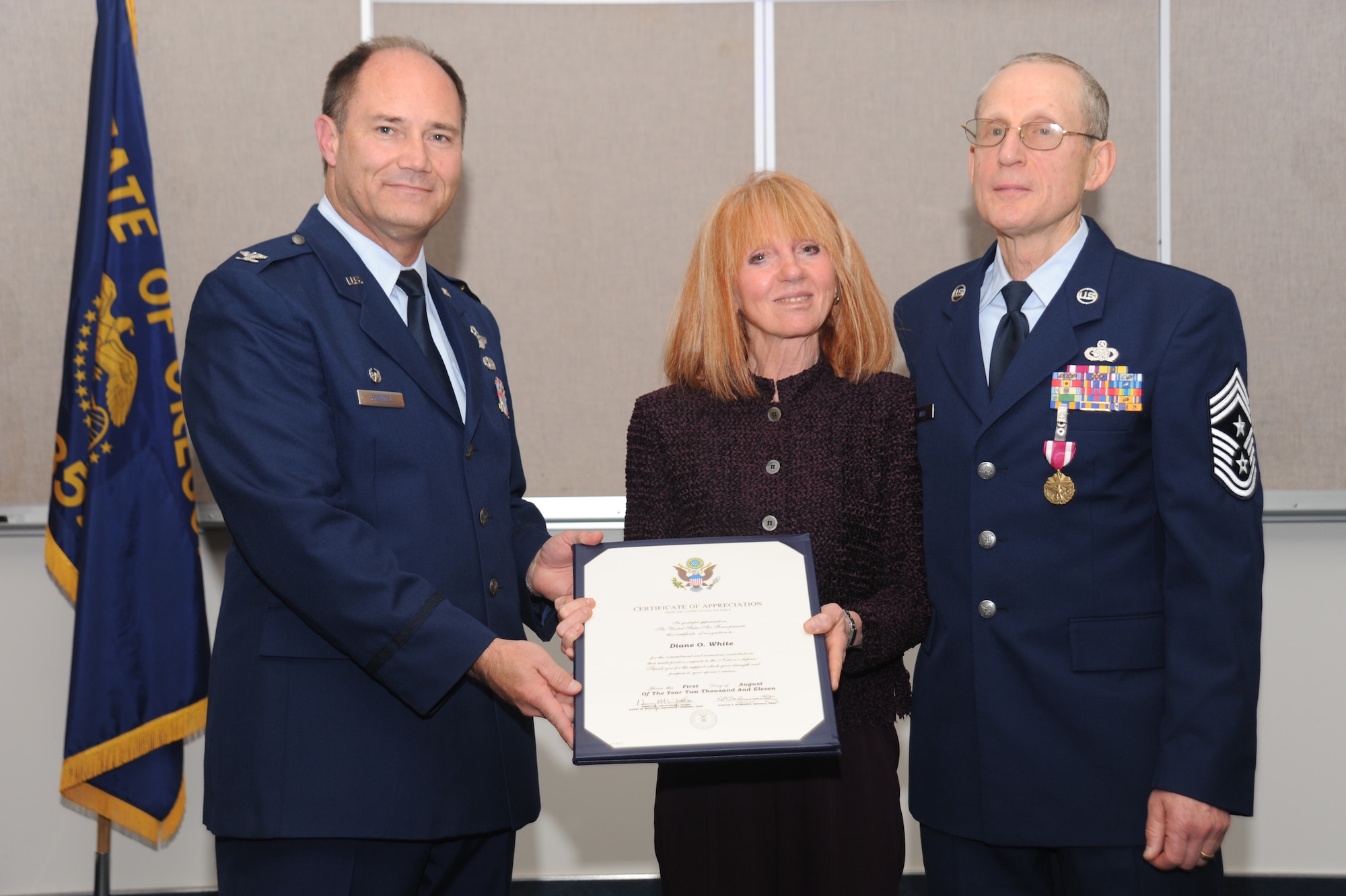 PORTLAND, Ore. - Diane White, Command Chief Max White's wife, received a certificate of appreciation from Col. Michael Stencel, 142d Fighter Wing Commander. The presentation was at Command Chief Max White's retirement ceremony October 16.(Air Force photo taken by Tech. Sgt John Hughel)