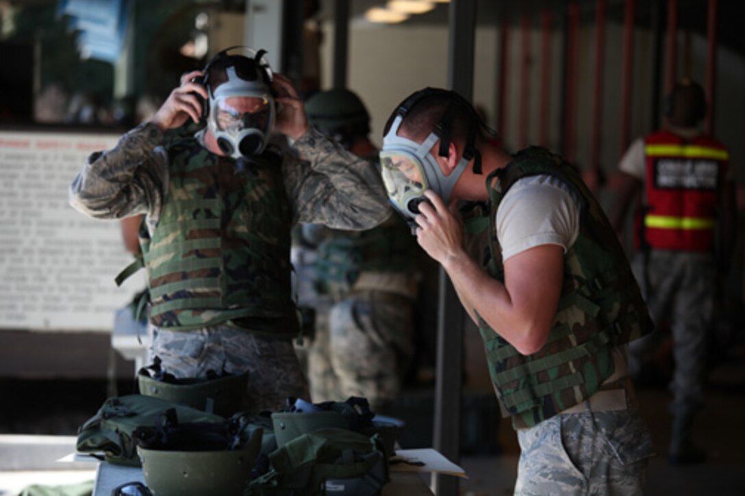 Airmen from the 560th Red Horse Squadron,  Joint Base Charleston, S.C. prepare to don their gas masks prior to qualifying for combat arms training and maintenance October 15, 2011 at JB CHS. (U.S. Air Force photo by Staff Sgt. Rashard Coaxum)