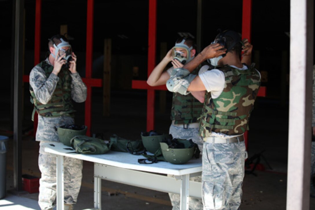 Airmen from the 560th Red Horse Squadron,  Joint Base Charleston, S.C. prepare to don their gas masks prior to qualifying for combat arms training and maintenance October 15, 2011 at JB CHS. (U.S. Air Force photo by Staff Sgt. Rashard Coaxum)