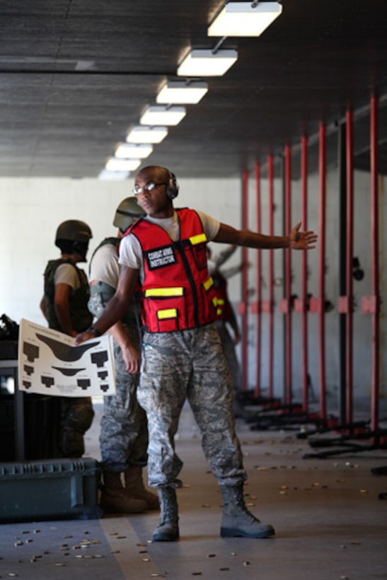 Senior Airman Clevon A. Boyd, a combat arms training and maintenance instructor with the 315 SFS, holds a qualification target in hand while providing instruction during CATM with the 560th Red Horse Squadron October 15, 2011. (U.S. Air Force photo by Staff Sgt. Rashard Coaxum)