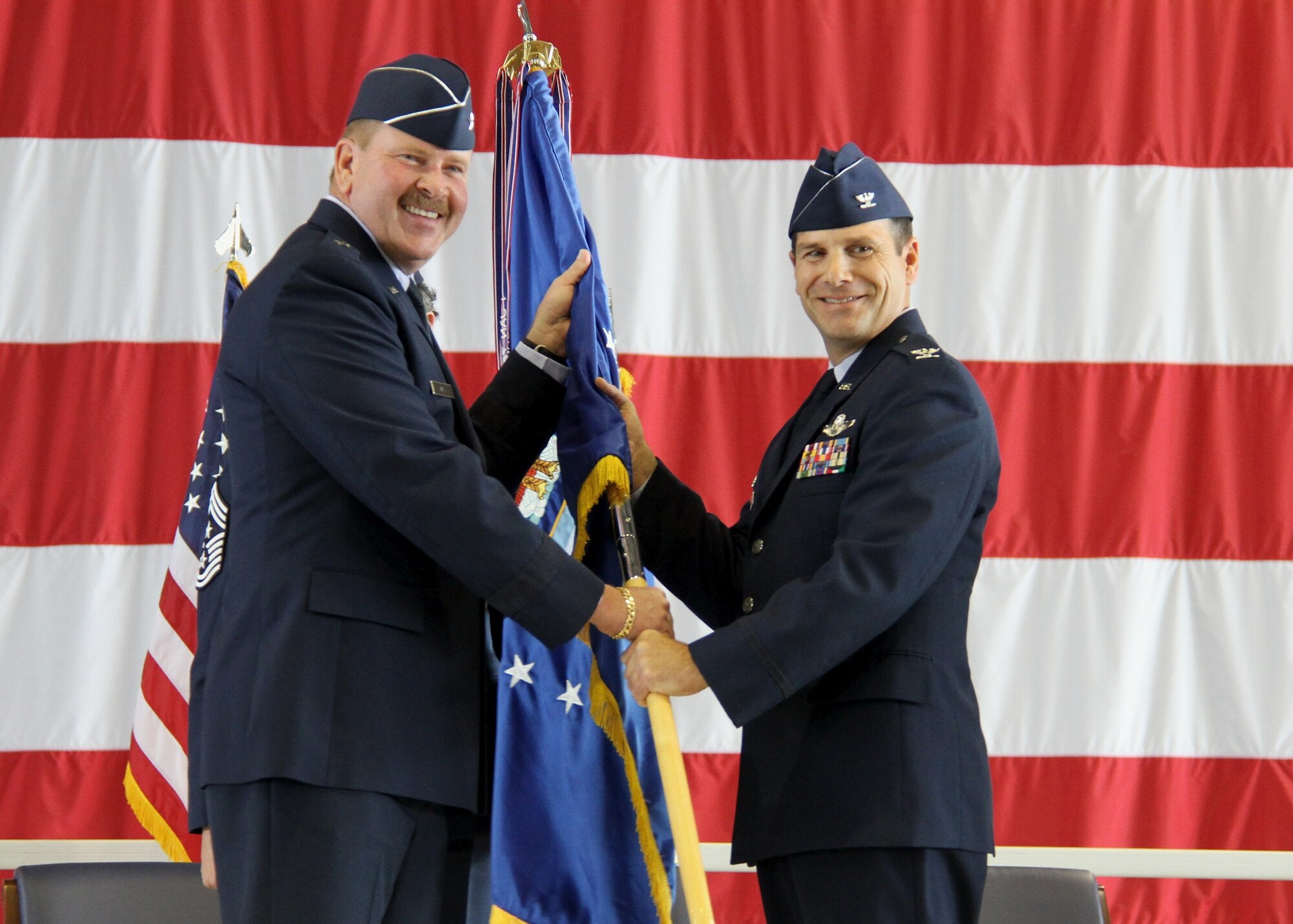 Brig. Gen. Mark A. Kyle, commander of Fourth Air Force, Air Force Reserve Command, presents Col. Albert V. Lupenski the 932nd Airlift Wing guidon during the change of command ceremony held Oct. 16 in Hangar One at Scott Air Force Base, Ill.  Most recently, Lupenski served as commander of the 349th Operations Group, Travis Air Force Base, Calif. (U.S. Air Force photo/ Tech. Sgt. Christopher Parr)