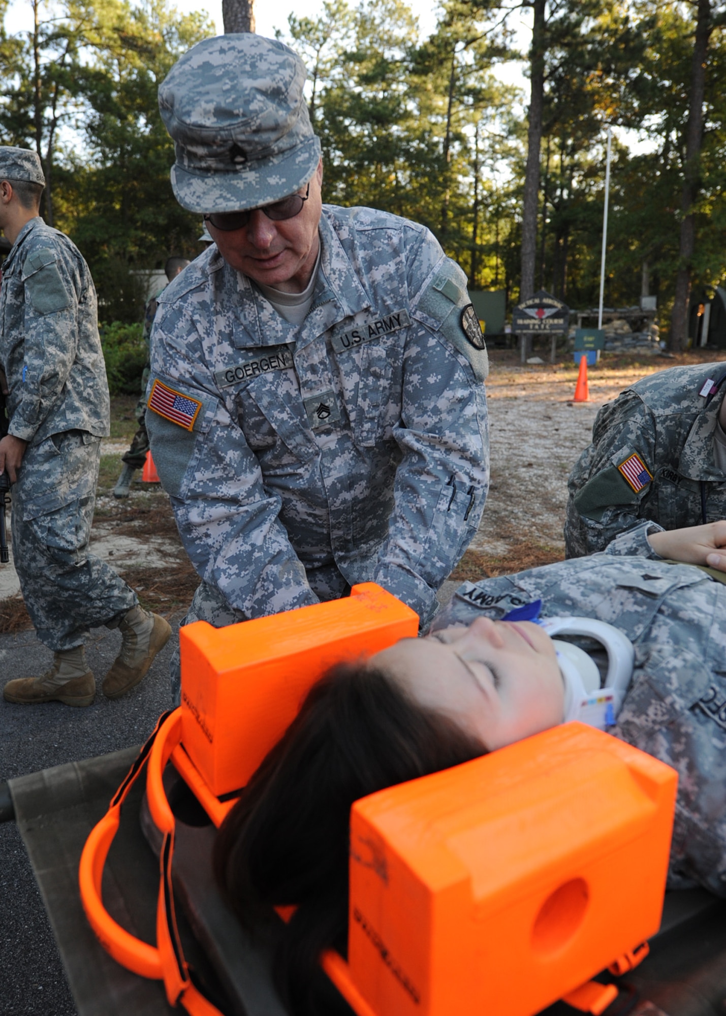 A medic with the 3274th U.S. Army Hospital assesses patient Sergeant Kelly Lonsford, a 3274th operating room technician, following evacuation from a blast site during a joint-force mass casualty medical evacuation training exercise at Fort Bragg, N.C., on Oct. 15, 2011.  The exercise was geared toward building communication and shared leadership responsibilities between the Army and Air Force medical staffs at Fort Bragg and Pope Field, N.C.  It combined simulated injuries and scenarios with real-world assets to replicate in-theater operational conditions.  (U.S. Air Force photo by Staff Sgt. Peter R. Miller) 