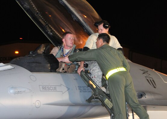 Brig. Gen. Jeff Johnson, 113th Wing Commander, D.C. Air National Guard, wishes a safe journey to Capt. Danny "Dirty" Hull, 121st Fighter Squadron pilot, before Capt. Hull's Air Expeditionary Force deployment Oct. 11.   More than 175 113 WG members departed on the Air Expeditionary Force deployment.    (U.S. Air Force photo/Tech Sgt. Craig Clapper)  
