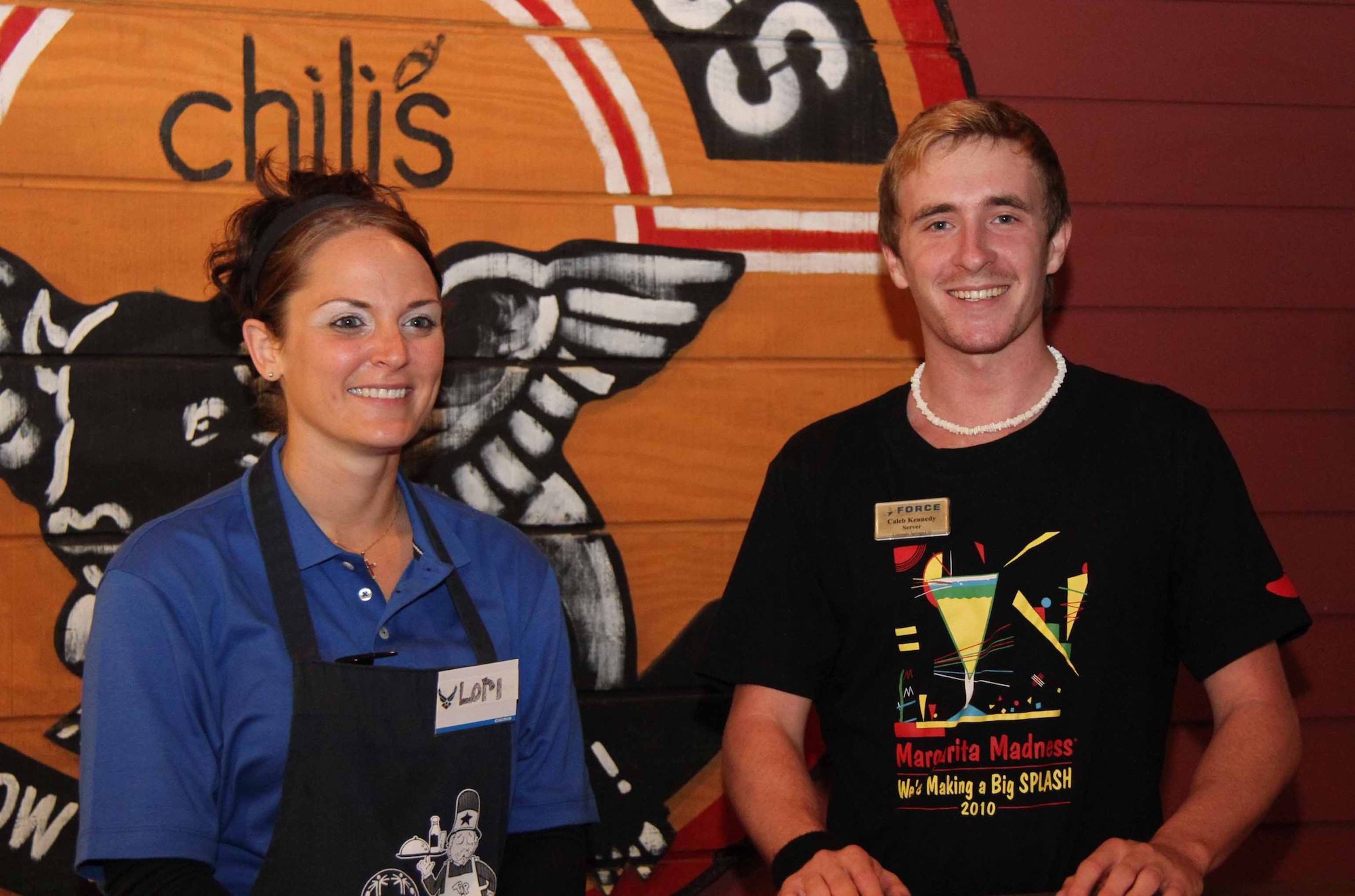 Chili's Waitress Jenny Shapiro serves customers with U.S. Air Force Airman 1st Class Cody Underwood, a member of the 18th Security Forces Squadron, during the 2011 Kadena Special Olympics "Tip-A-Cop" event, Oct. 14. Volunteers raised more than $2,500 in support of the Special Olympics, which takes place Nov. 4 at Kadena Air Base. (U.S. Army photo/Chip Steitz)