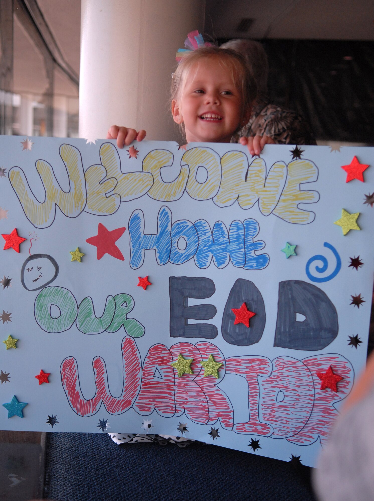 Madison Dutton waits for her daddy, Staff Sgt. DJ Dutton, to arrive home at the Honolulu International Airport Oct. 16 following a deployment to Afghanistan. Dutton, an explosive ordnance disposal technician deployed from the 647th Civil Engineer Squadron at Joint Base Pearl Harbor-Hickam, Hawaii, was wounded by an improvised explosive device Sept. 14 in Afghanistan. He was treated at Brooks Army Medical Center, Texas, before returning to his wife, Stacy, and two children. (U.S. Air Force photo by Staff Sgt. Carolyn Herrick)