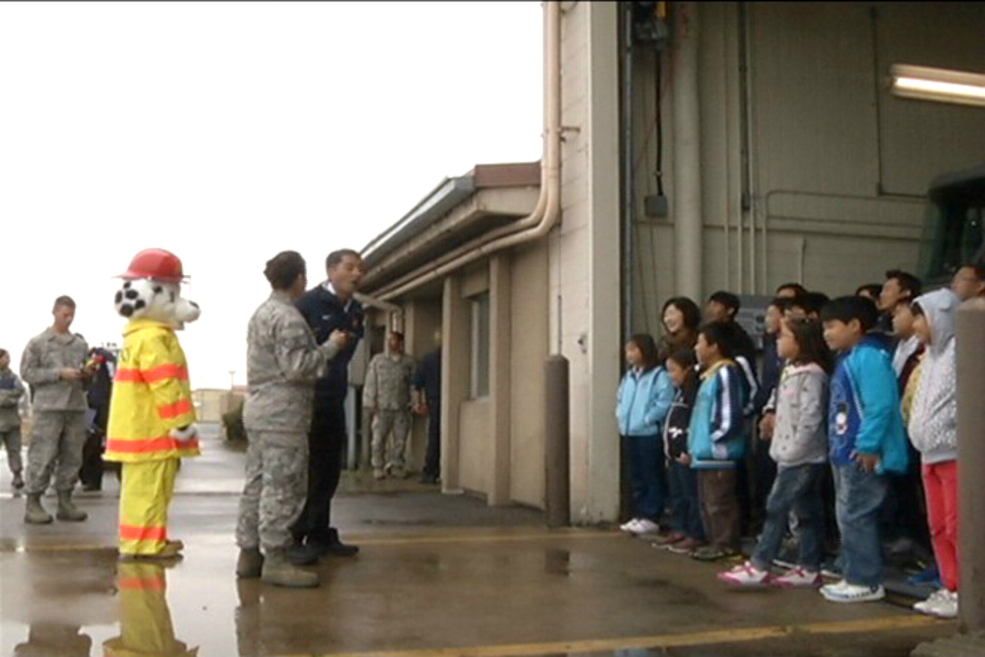 A group of Korean students of Sinsido, Biyondo and Yamido Elementary Schools from islands near Gunsan City are briefed by members of the 8th Civil Engineer Squadron fire department during a tour at Kunsan Air Base, Republic of Korea, Oct. 14, 2011. (U.S. Army photo by Spc. Christopher Wellner/Released)