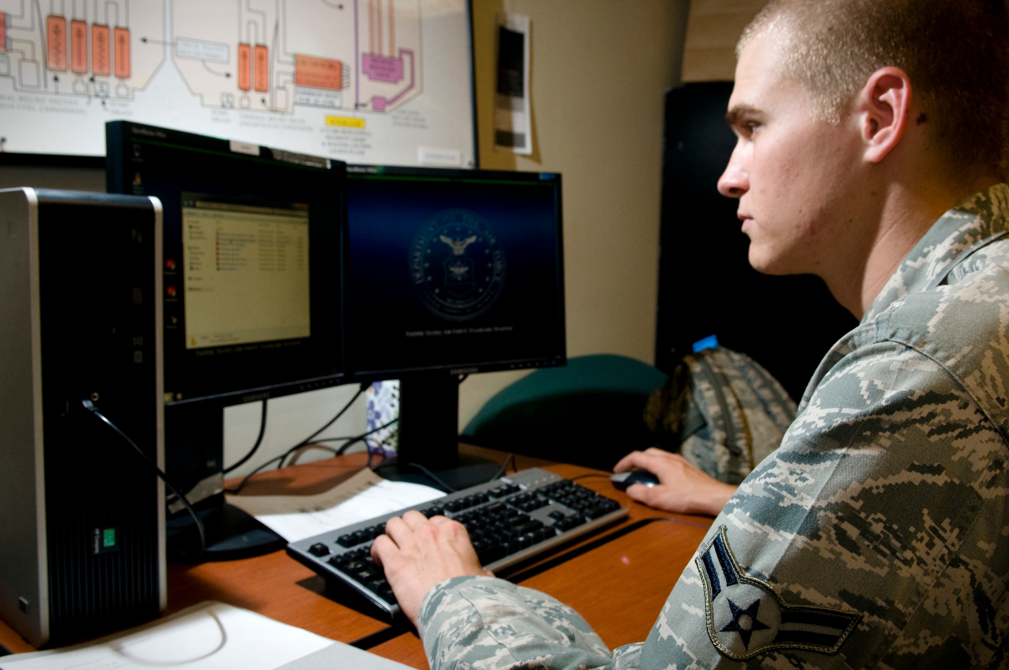 U.S. Air Force Airman 1st Class Corey Schacht, 18th Communications Squadron client systems technician, installs essential computer updates on an Air Force desktop on Kadena Air Base, Japan, Oct. 14. The 18th CS network section contains a tiered system of proficient technicians who keep computers, office and mobile phones around the base, a total of approximately 10,000 machines for 12,000 users, running from the first time they're plugged in to maintaining them down the road. (U.S. Air Force photo/Airman 1st Class Maeson L. Elleman/released)