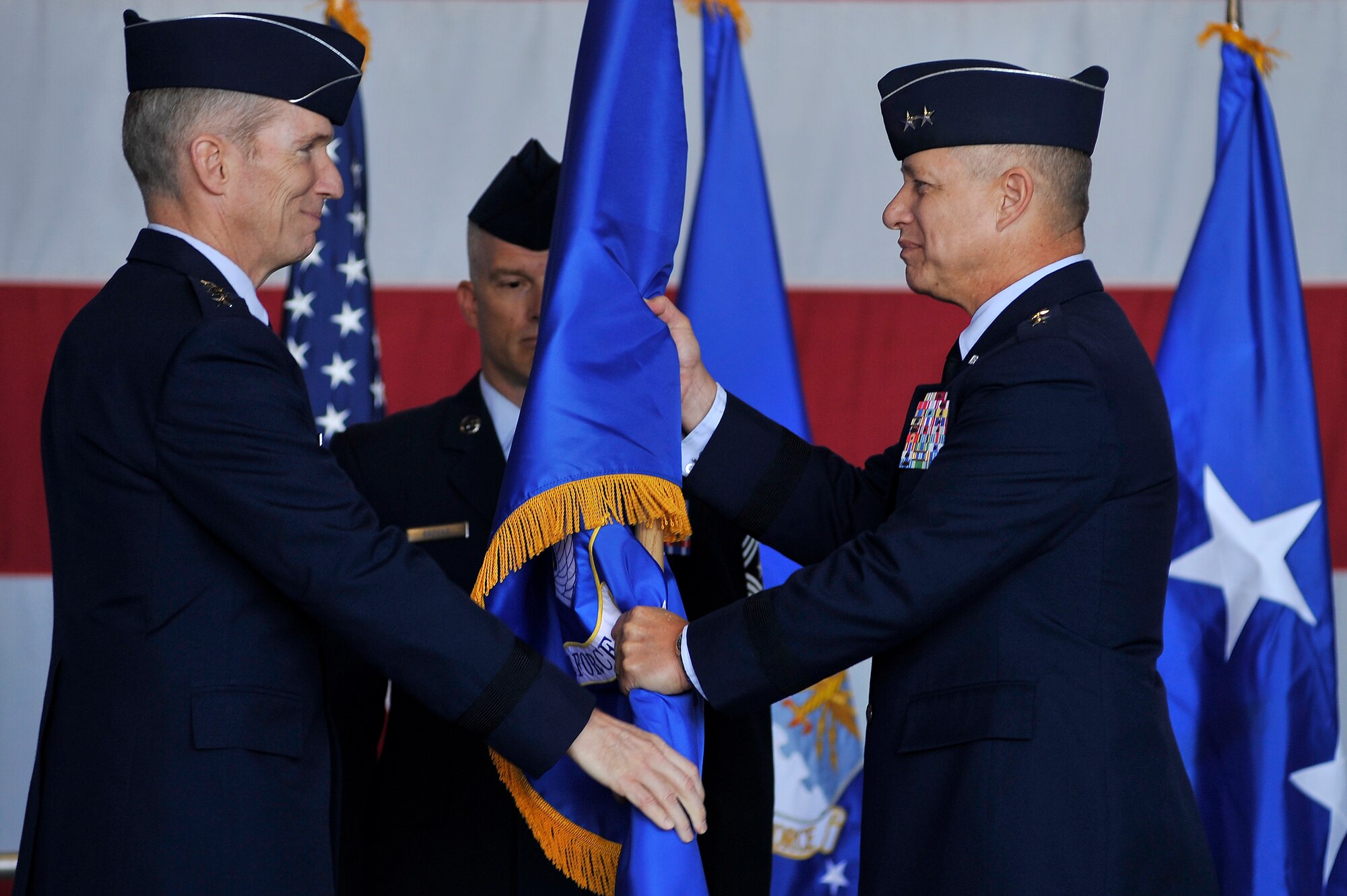 Maj. Gen. Lawrence Wells takes the 9th Air Force flag from Gen. Mike Hostage, commander of Air Combat Command, during the 9th Air Force change of command ceremony at Shaw Air Force Base, S.C., Oct 17. The Ninth Air Force is comprised of seven wings and two direct reporting units in the eastern United States with more than 350 aircraft, and 24,000 active duty and civilian personnel. (U.S. Air Force photo by Senior Airman Kenny Holston/Released)


