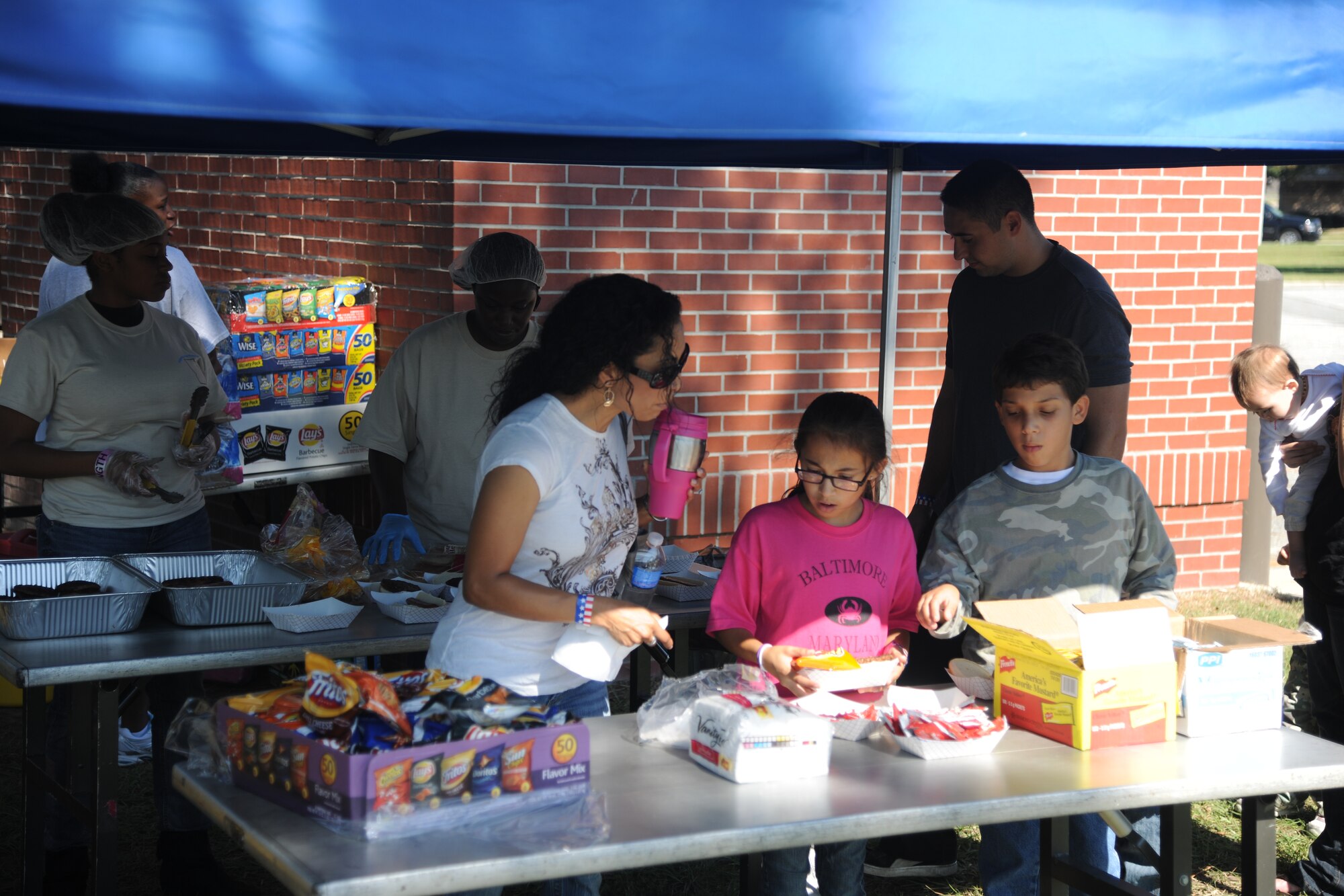 Moody Air Force Base’s Kids Deployment Line participants take a break to enjoy lunch on Oct. 15, 2011. Airmen from across Moody AFB, Ga. volunteered to help put the event together by helping with lunch, passing out bags and being group leaders. (U.S. Air Force photo by Airman 1st Class Paul Francis/Released)
