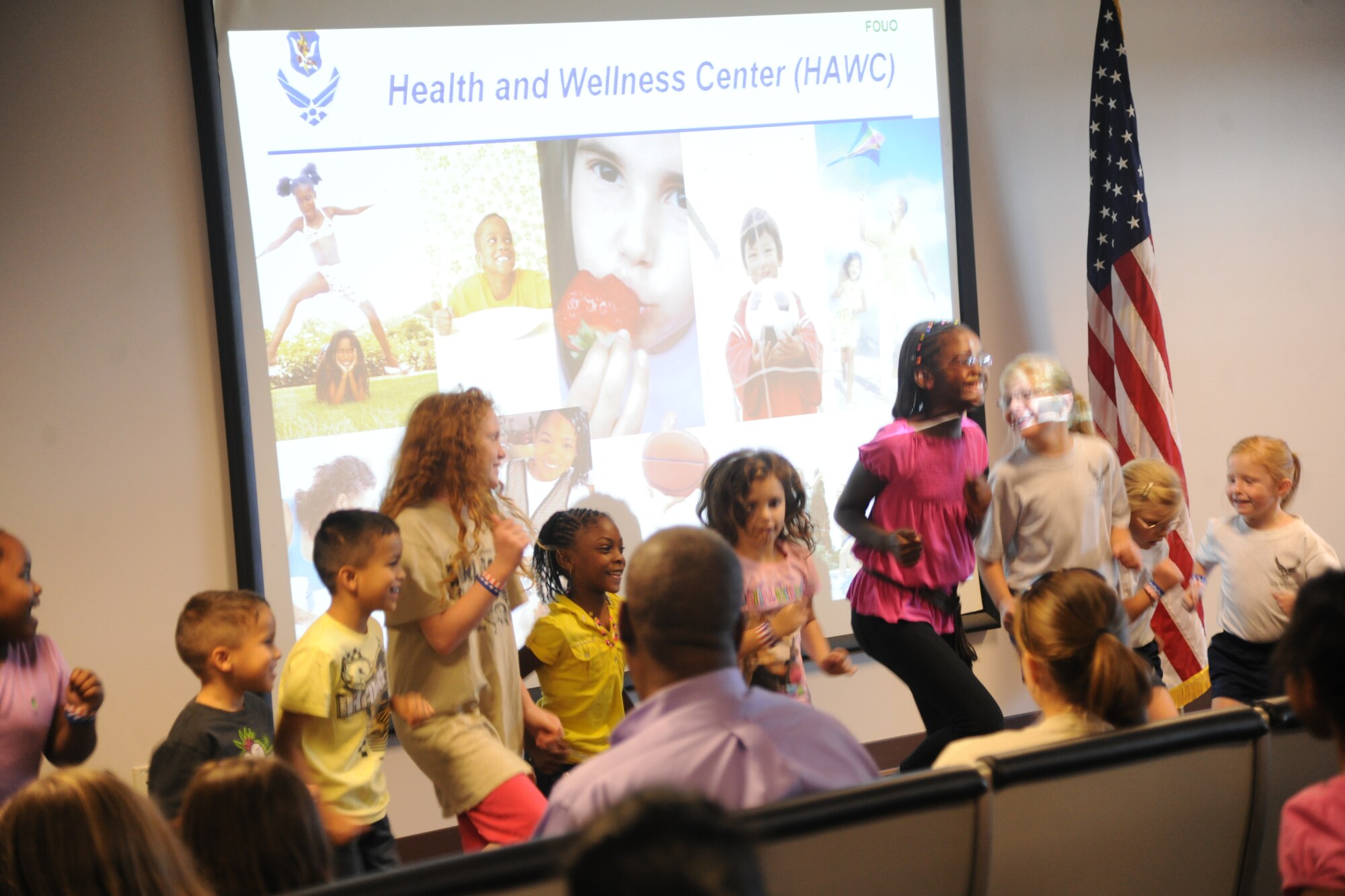 Children run in place for the Health and Wellness Center presentation about the importance of exercise at Moody Air Force Base Ga., Oct. 15, 2011, during the Kids Deployment Line. Various briefings were given by five squadrons   to inform the kids on the Air Force’s mission and the steps AF personnel take to prepare for deployments. (U.S. Air Force photo by Airman 1st Class Paul Francis/Released)
