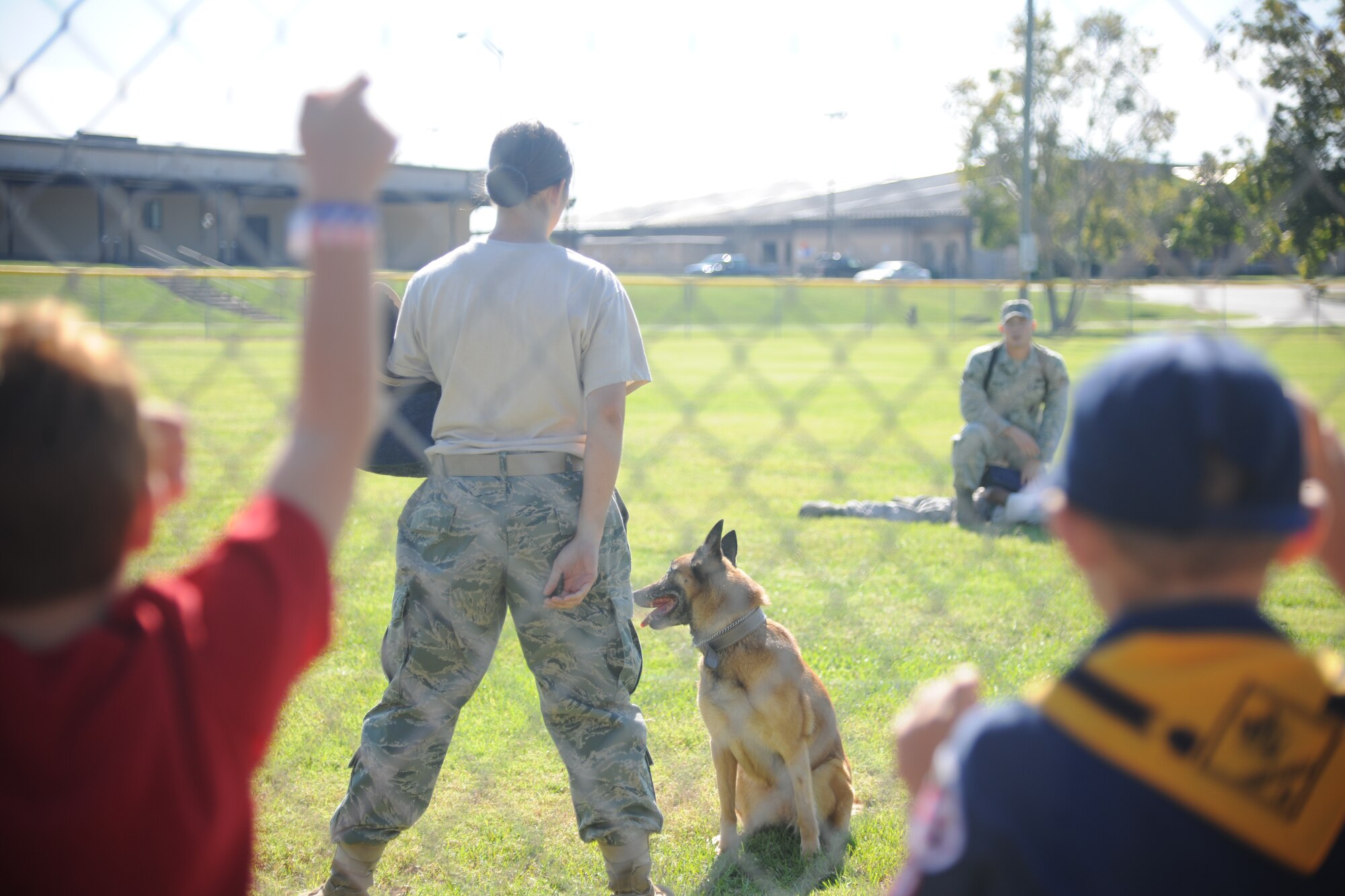 A K-9 demonstration takes place on the softball field at Moody Air Force Base Ga., Oct. 15, 2011. The demonstration was one of five events that showed families how the 23rd Security Force Squadron would react if there was an intruder in a deployed environment. (U.S. Air Force photo by Airman 1st Class Paul Francis/Released)
